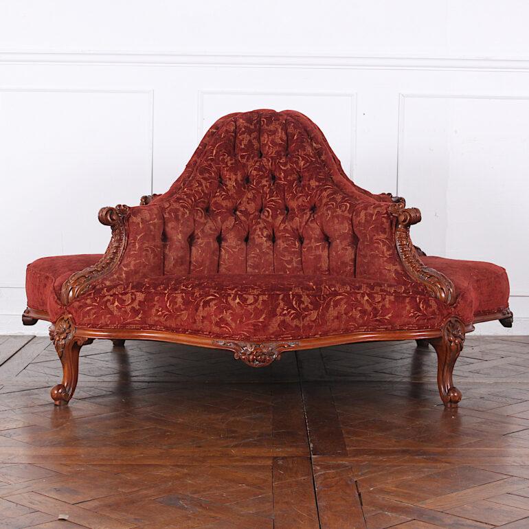 A rare 19th century four seated round upholstered conversation sofa or 'gossip bench', heavily carved to the legs and skirt and with carved scrolled arms between each of the four seats. Later upholstery still in very good condition.

 
