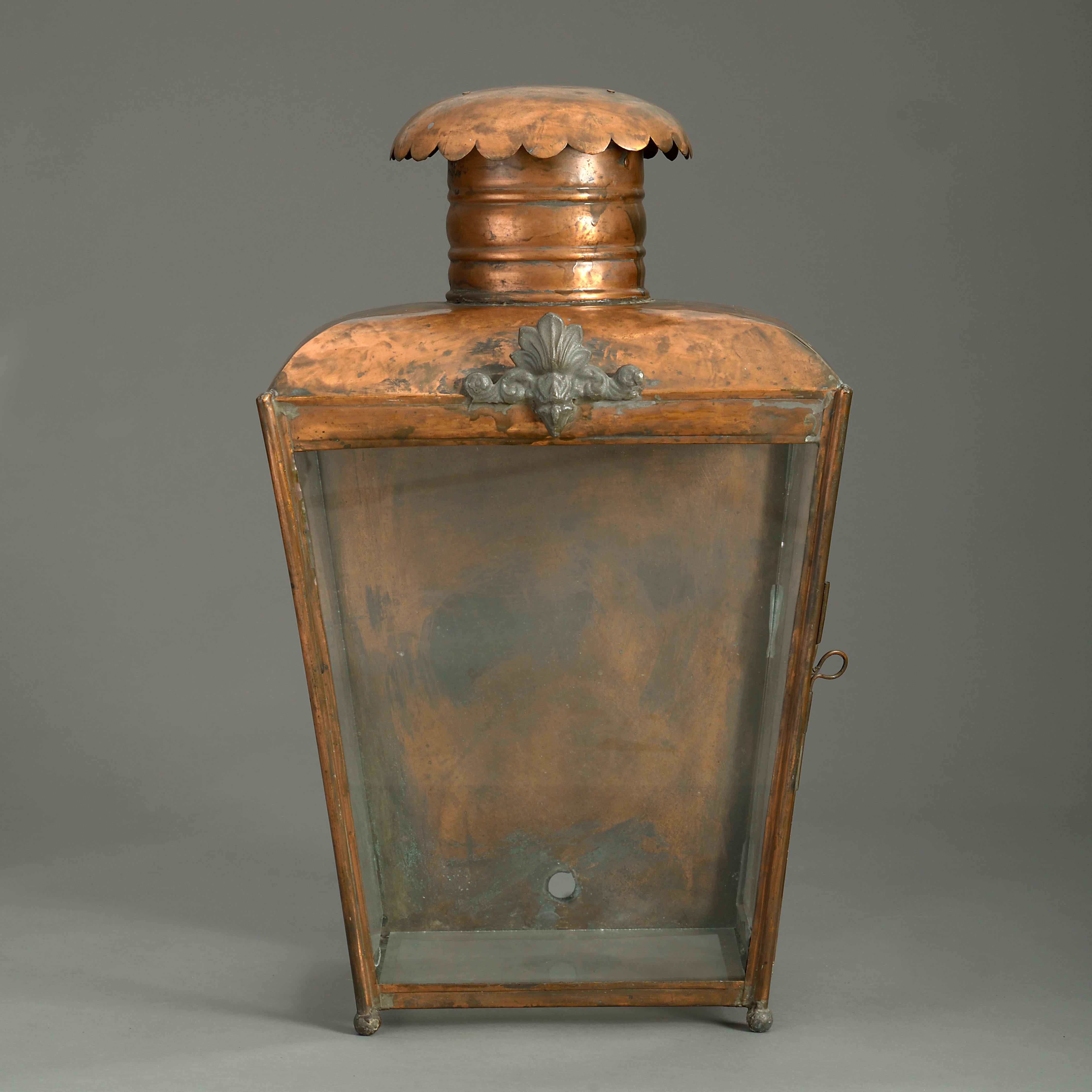 A late 19th century Victorian Period copper wall lantern, of square tapering form with glazed front and sides and having a chimney with scalloped cowl.