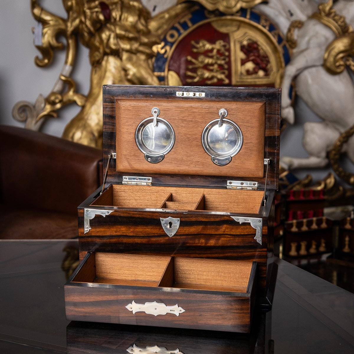 Antique early 20th century Victorian coromandel wood smoker's compendium box with solid silver mounts, two top drawers for cigarettes and cigars and two small compartments for matches, as the top lid is lifted the bottom draw automatically pulls out