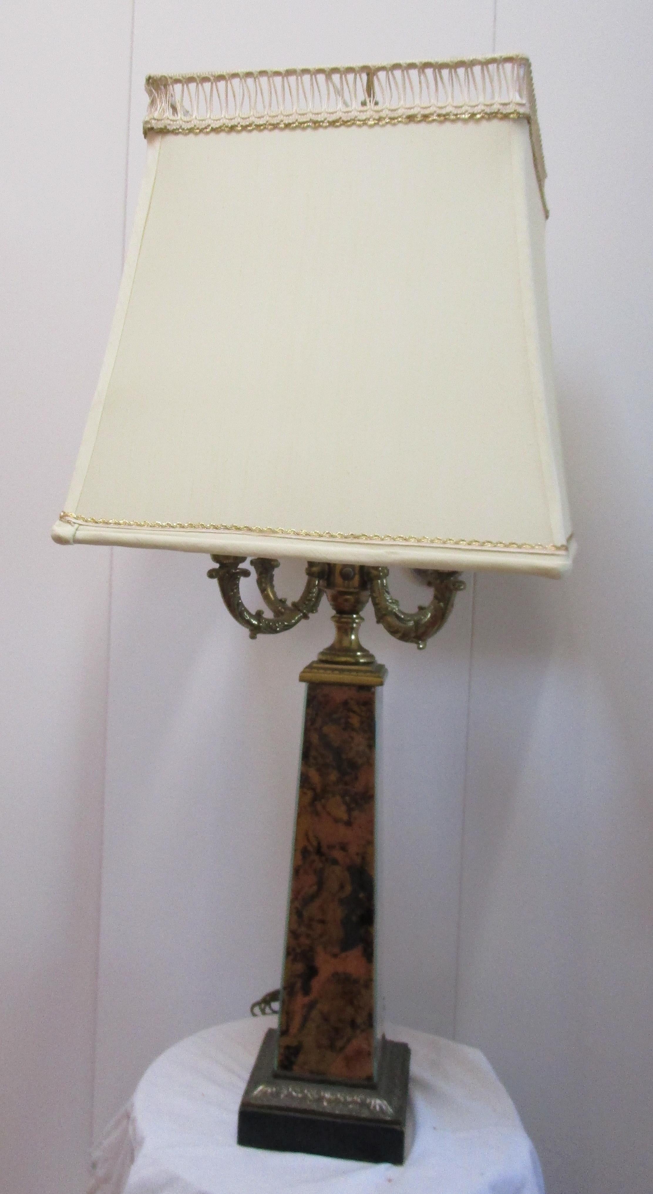 This is a rare and beautiful Victorian era lamp. It was converted from a candelabra at some point in its history. It is surmounted by a silk box shade in eggshell colored silk with metal trim that has been completely restored. The lamp with four