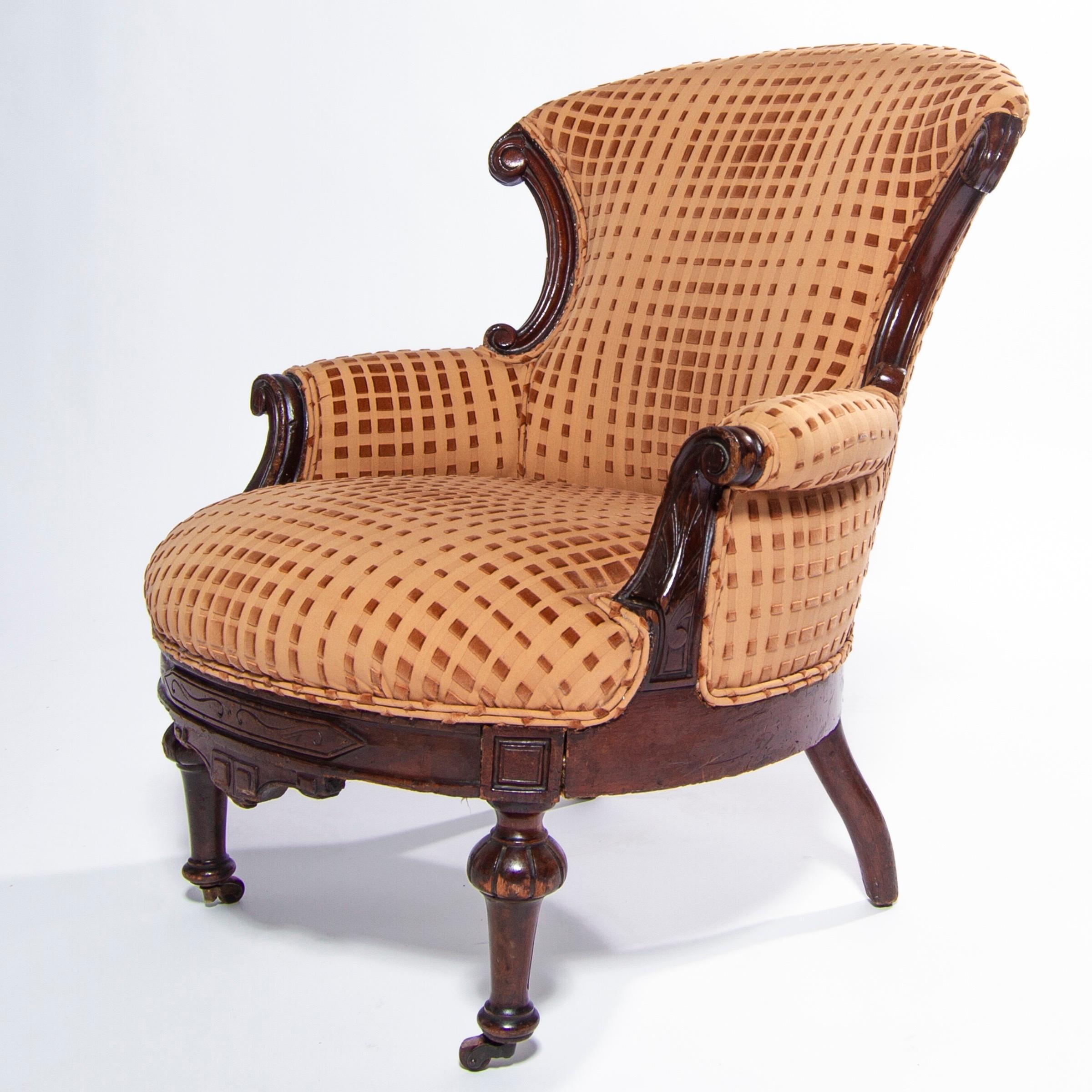 Beautiful example of late 1800s Victorian Eastlake chair. Rendered in hand turned and hand carved walnut upholstered in a Op Art cut velvet. England.