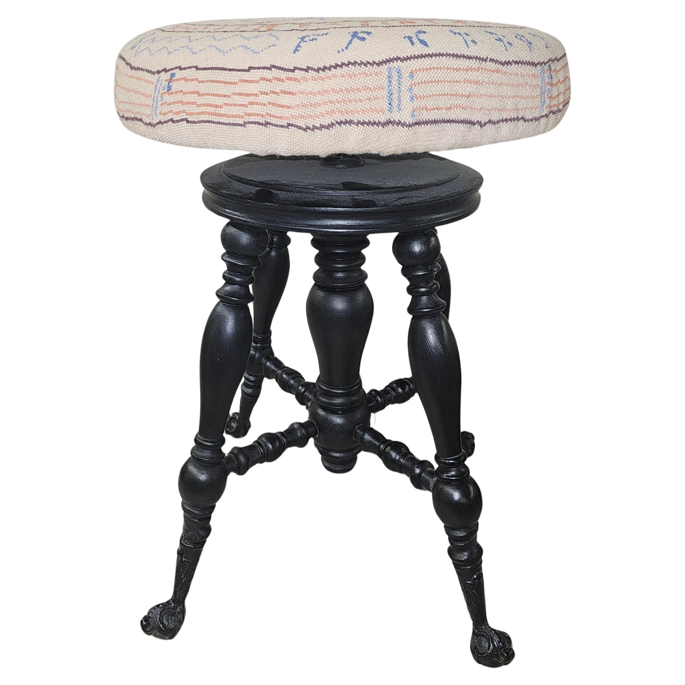 19th Century Victorian Ebonized Wood and Needlepoint Upholstered  Piano Stool. Newer Needlepoint upholstery with various music notes decorated. Adjustable seat high 19 to 23