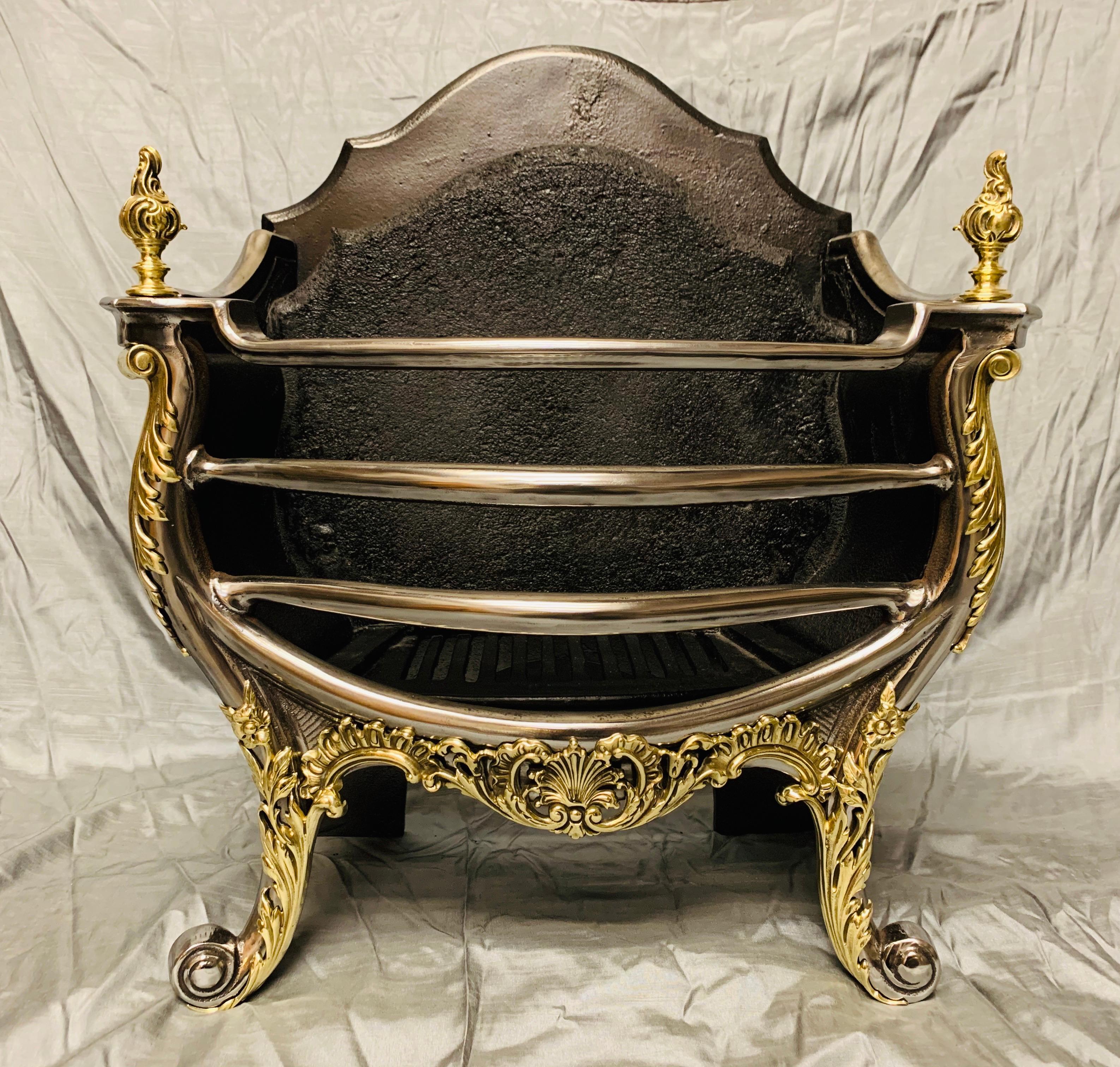 A completely original 19th century Victorian polished cast iron and mounted polished brass fire basket grate in the Rococo style. A shaped high back complete with its original fire stone, with a four bar serpentine polished grate front topped by