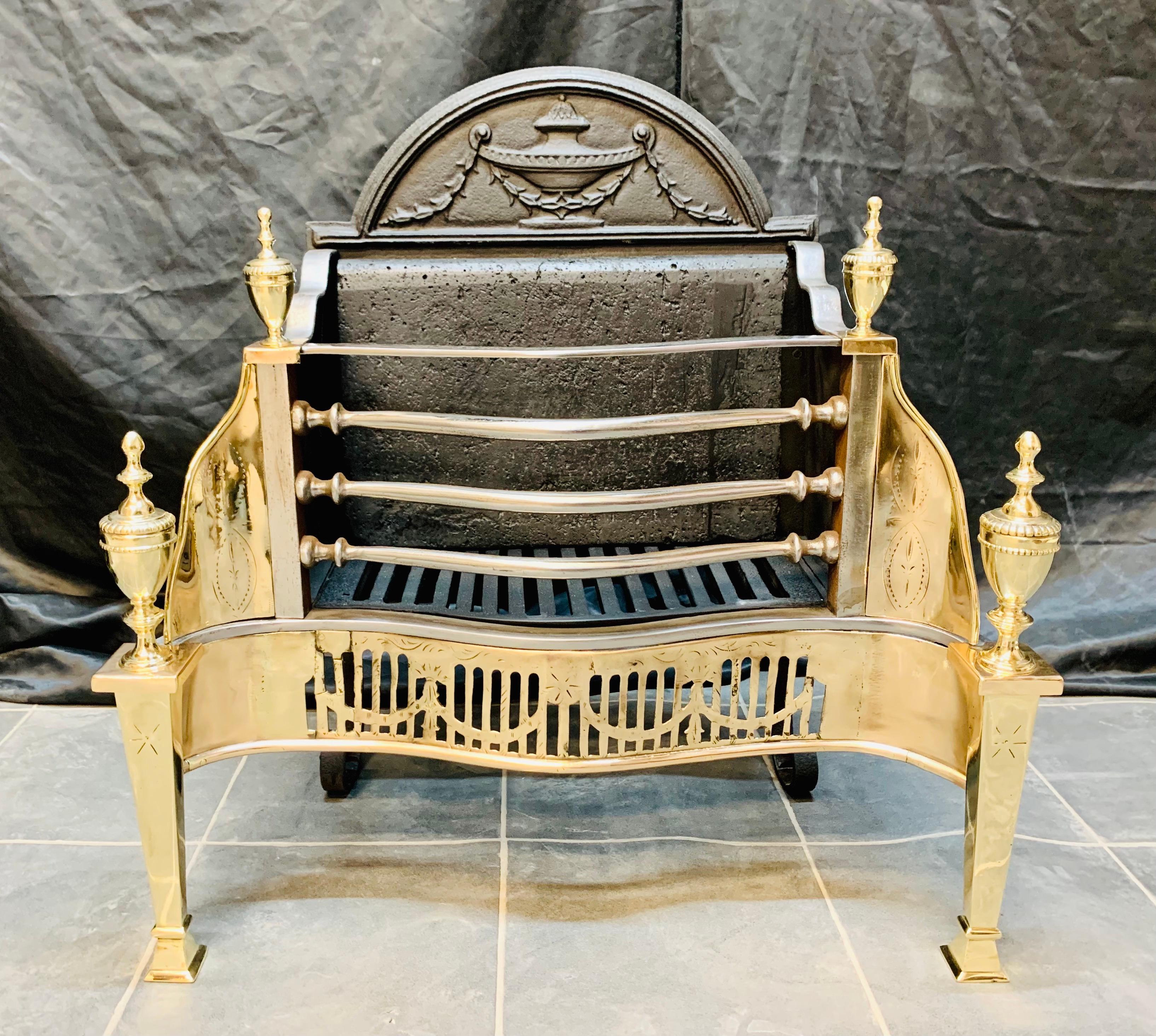 A 19th Century Victorian fire grate in the Georgian manner probably by T. Elisley.
A high arch back plate with a cast central urn and trailing bellflowers each side, flanked by shaped sides and polished square standard posts mounted with polished
