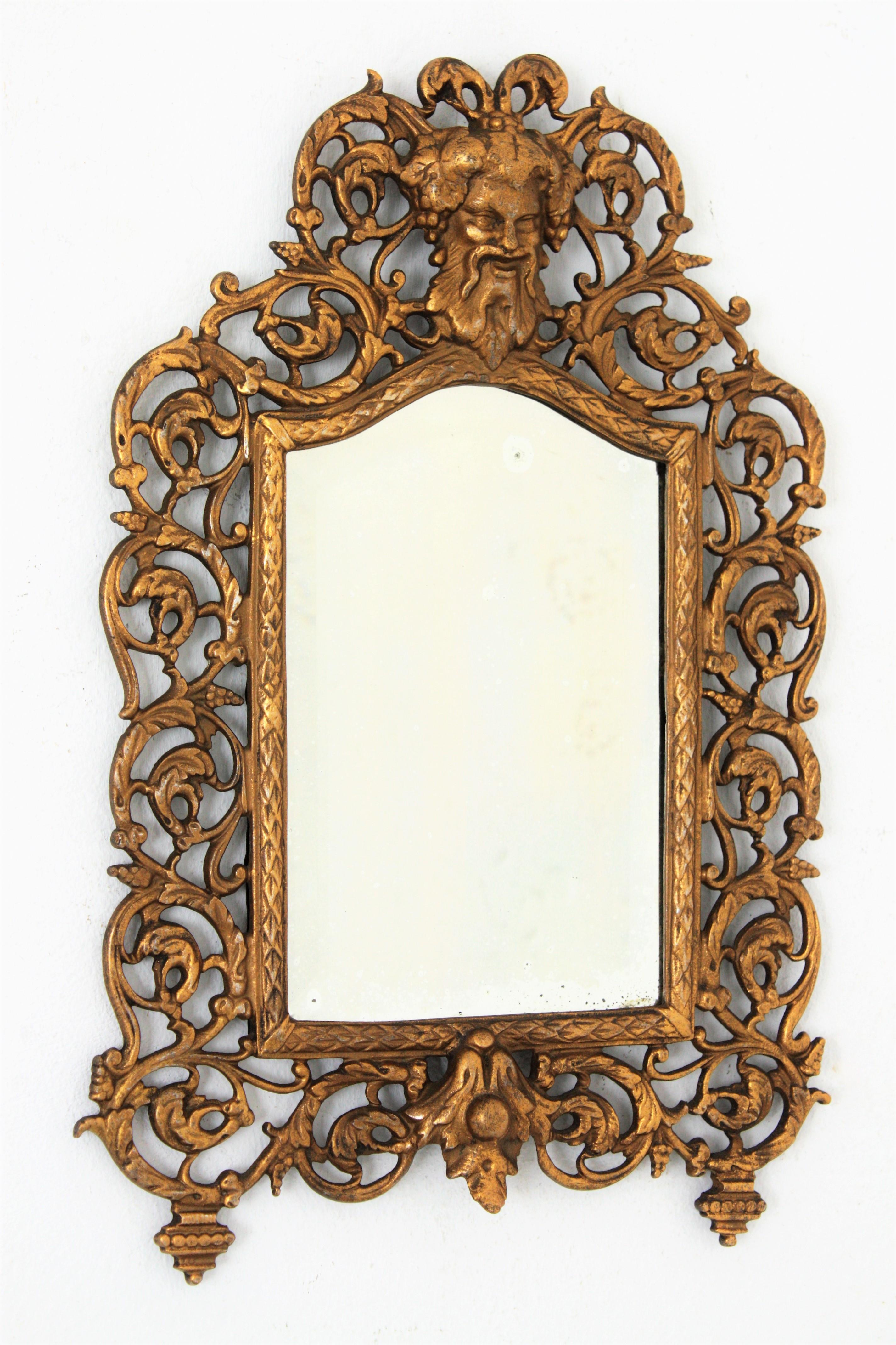 Victorian Vanity Mirror / Wall Mirror, Beveled Glass, Gilt Iron
An elegant Bradley & Hubbard Victorian wrought iron small mirror with beveled glass, naturalistic design on the frame and a Classical Greek God of Wine Bacchus head adorning the top.