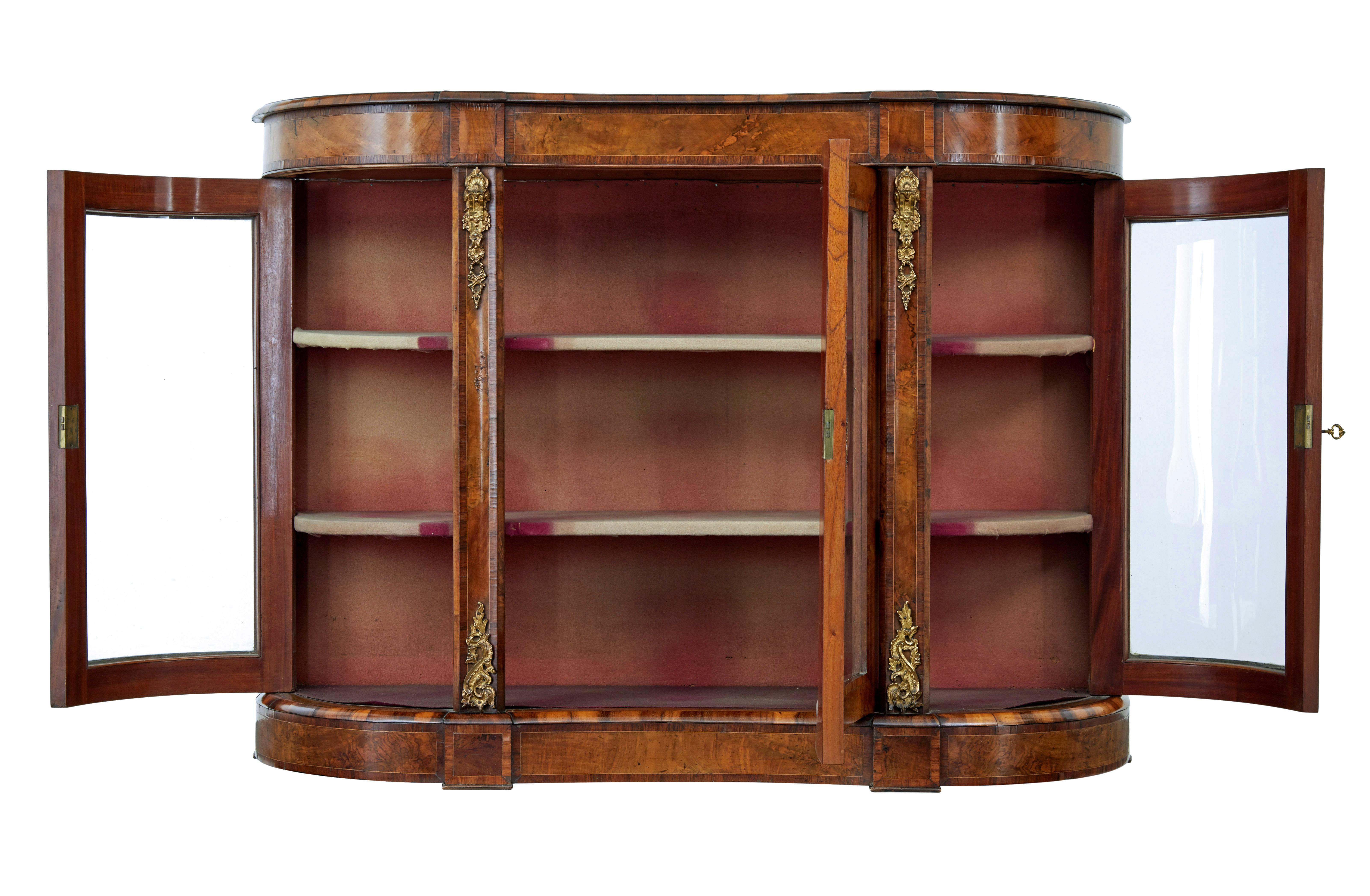19th century Victorian glazed walnut sideboard circa 1870.

Good quality high Victorian walnut credenza.

Beautifully shaped front with concave centre.  Central glazed door flanked either side by shaped doors each end.  Each containing 2 shelves for