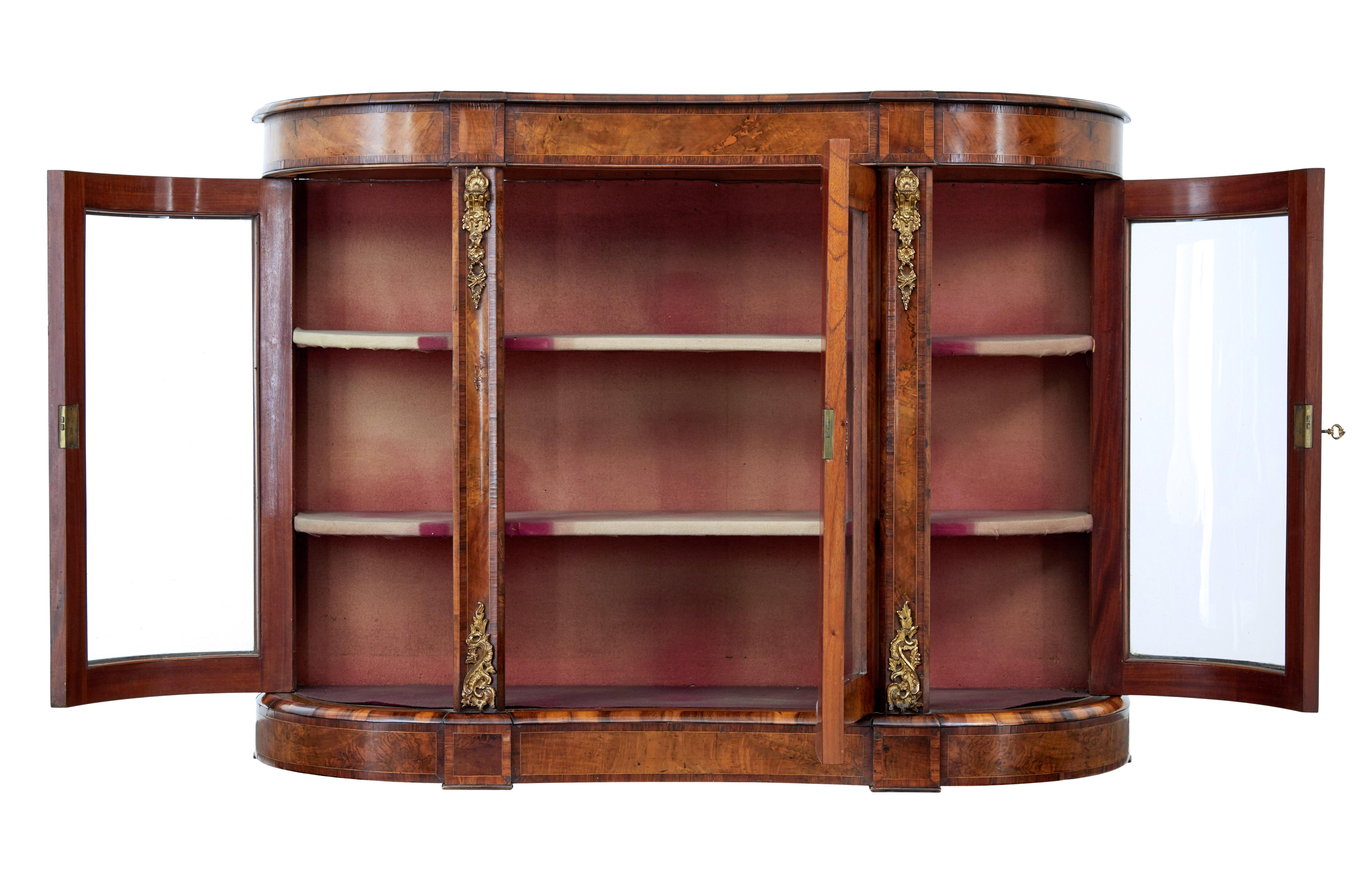 19th century victorian glazed walnut sideboard circa 1870.

Good quality high Victorian walnut credenza.

Beautifully shaped front with concave centre.  Central glazed door flanked either side by shaped doors each end.  Each containing 2 shelves for