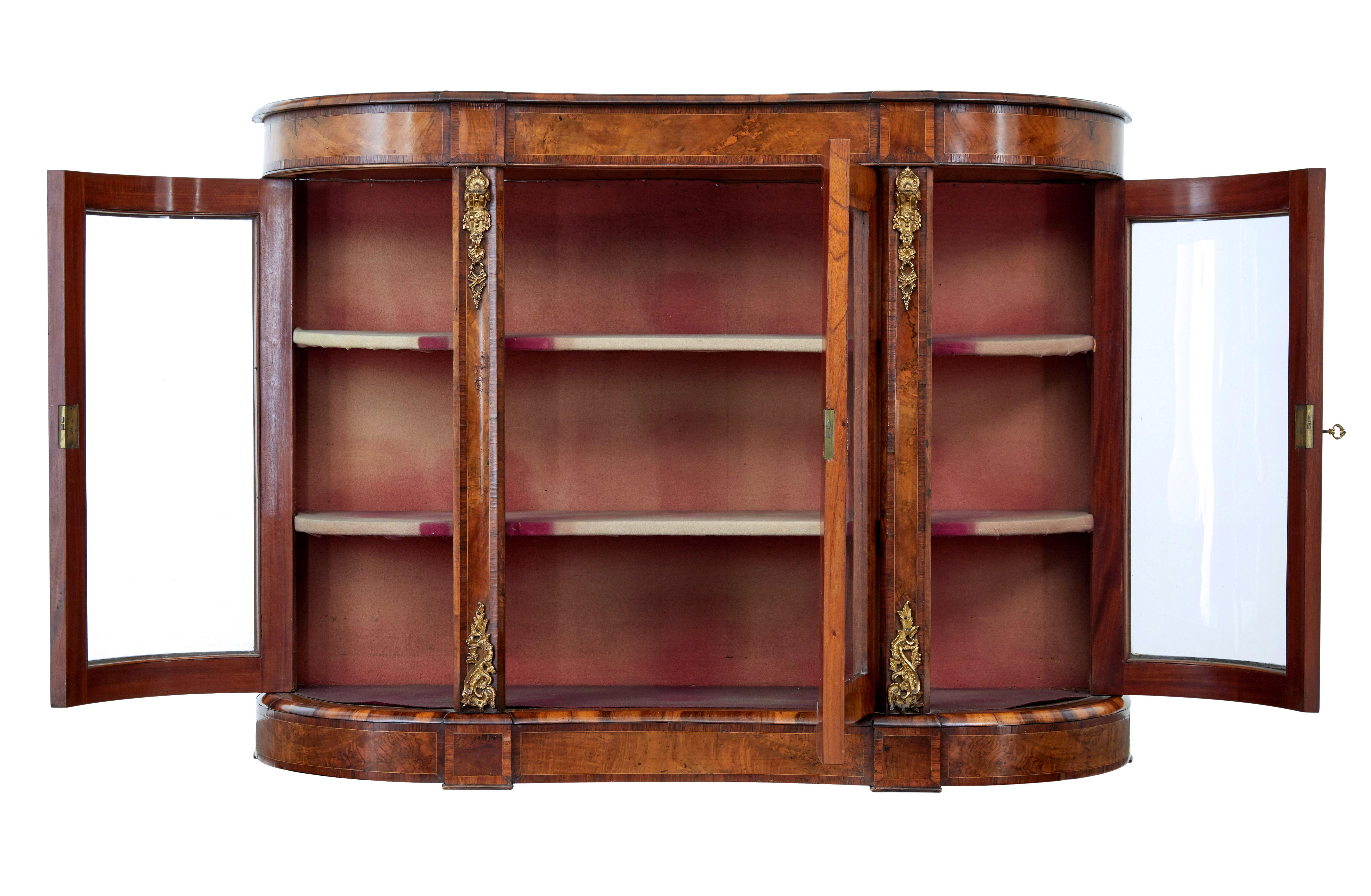 19th century Victorian glazed walnut sideboard circa 1870.

Good quality high Victorian walnut credenza.

Beautifully shaped front with concave centre.  Central glazed door flanked either side by shaped doors each end.  Each containing 2 shelves for