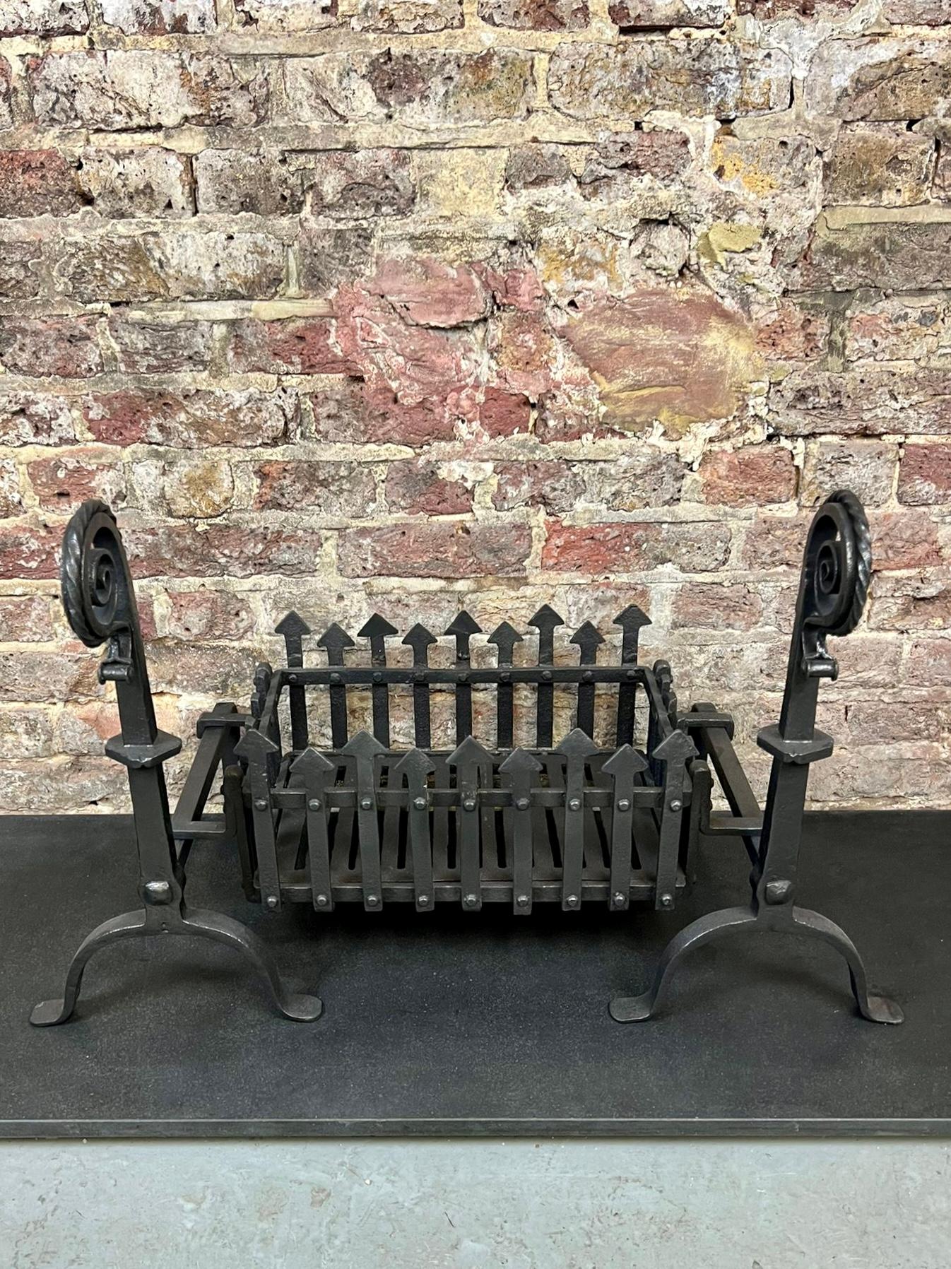 19th century Victorian Gothic fireplace grate. 
Traditional blackened finished basket grate with church like spike fencing flanked & support by Serpent Style Andirons / Fire Dogs.
Recently Salvaged from An English Cambridgeshire Manor