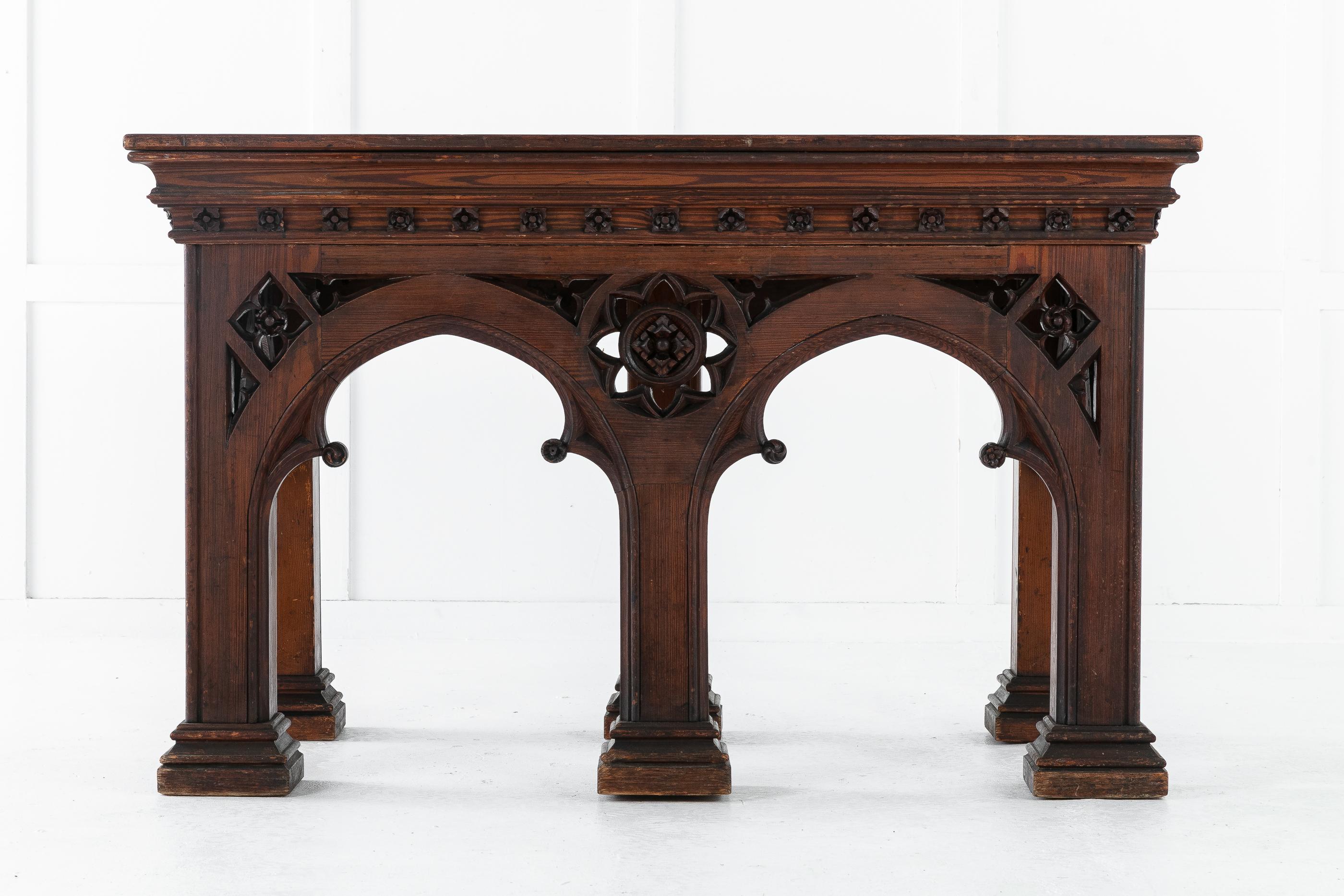 A large and very impressive 19th century Victorian Gothic console table. Having Gothic lancet arcade arches, supported by large square feet, with a central carved florette to the front.