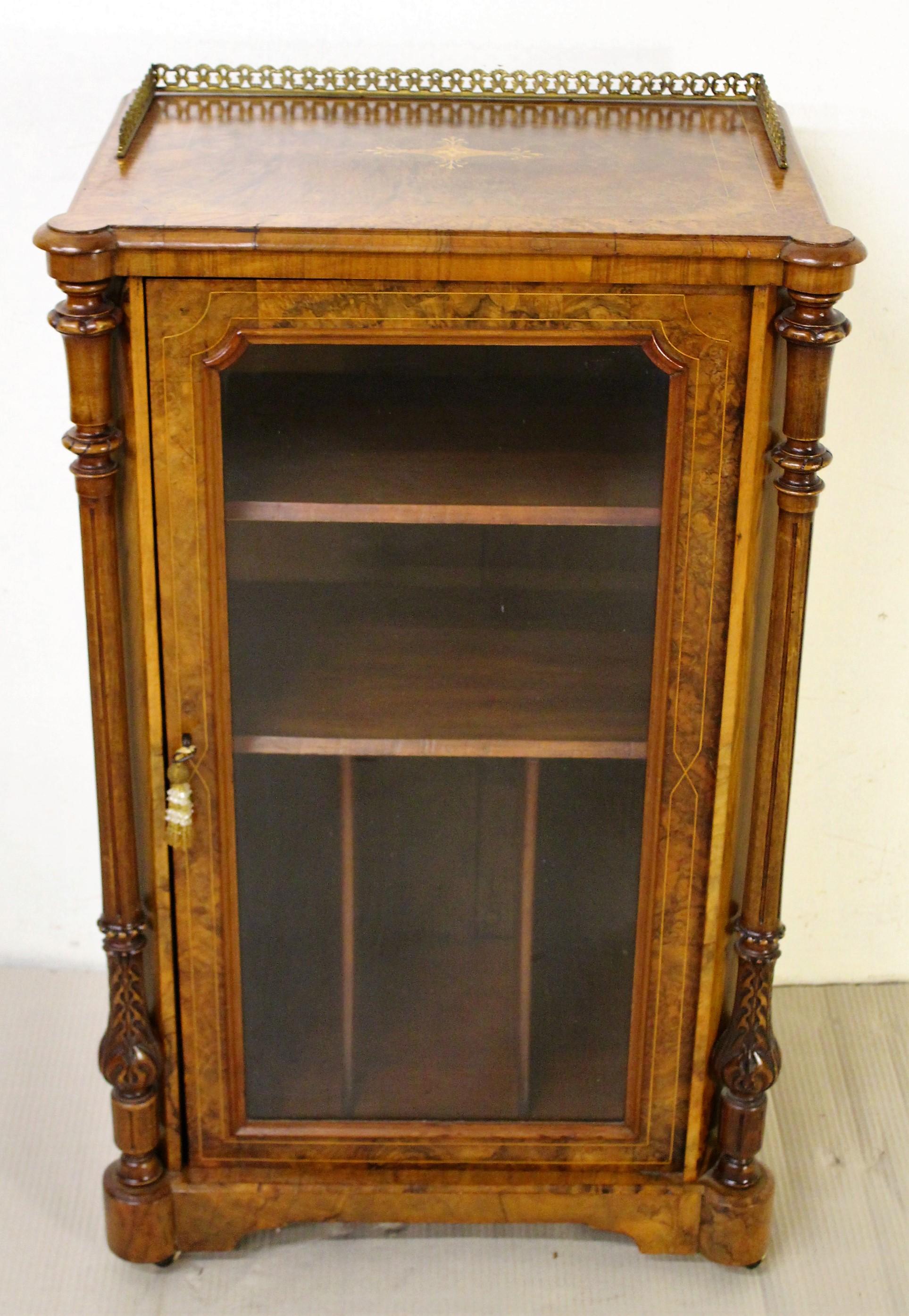 An excellent mid-Victorian period inlaid burr walnut music cabinet. Very well made in solid walnut with stunning burr walnut veneers. Decorated throughout with fine inlaid detailing in boxwood. The top is fitted with a 3/4 surround brass gallery and