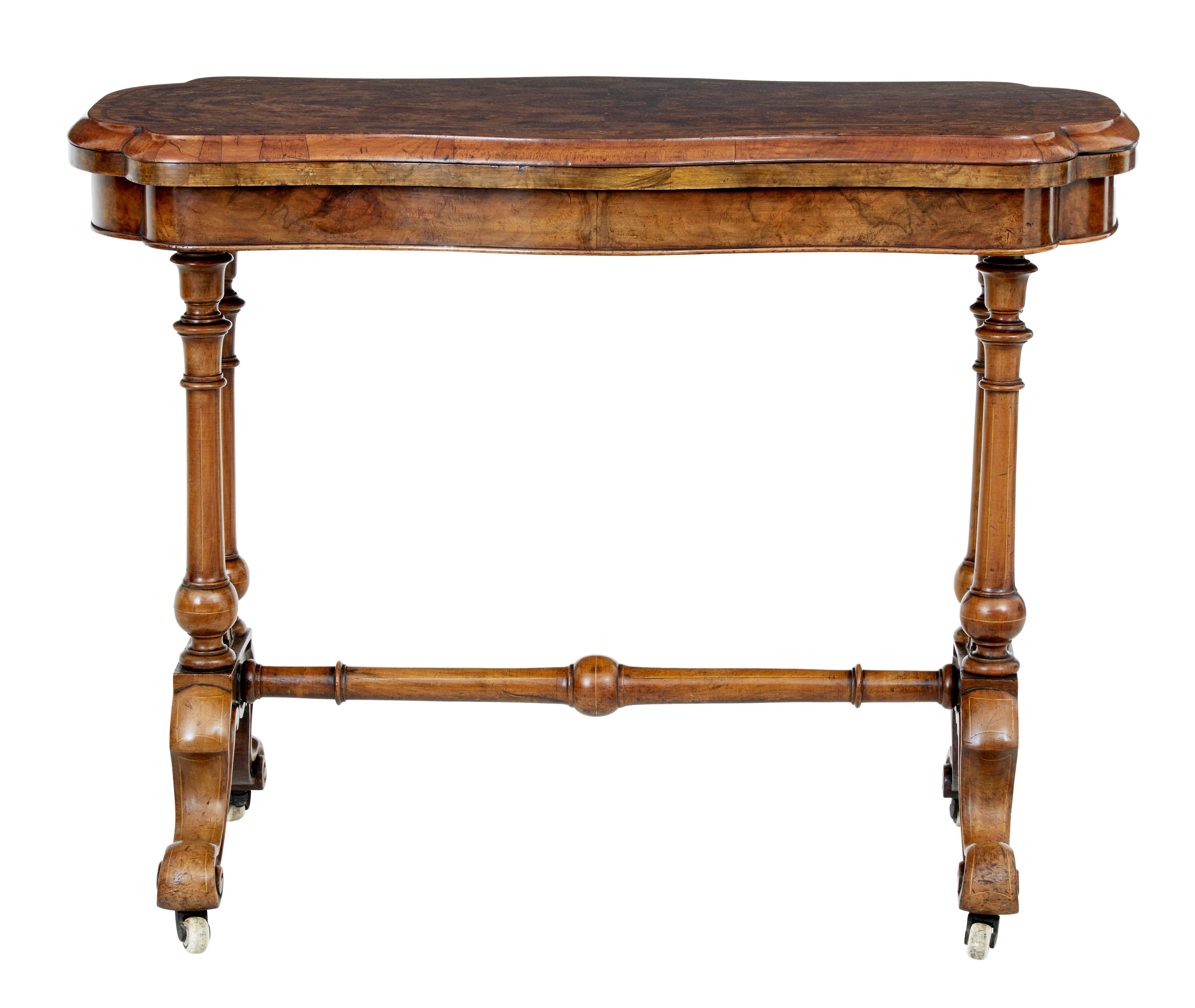 Decorative high Victorian walnut card table, circa 1870.

Shaped burr walnut top with inlaid patterns and crossbanded decoration. Top swivels to reveal a storage well and opens to a green baize playing surface.

Standing on 4 turned legs united