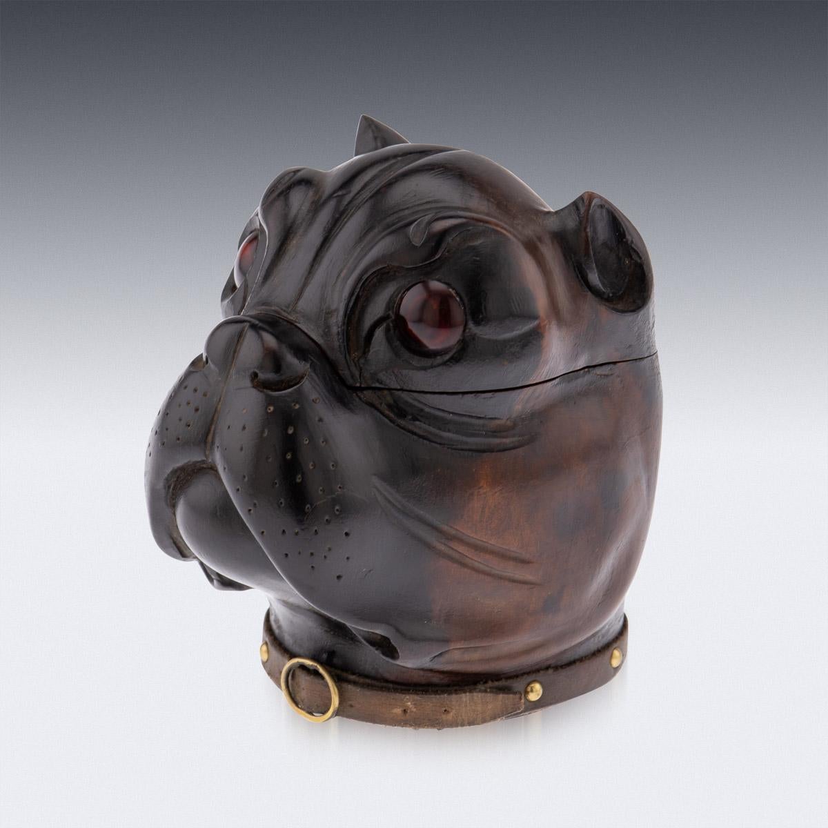 19th century Victorian lignum vitae inkwell modelled as the head of a bulldog with realistic red glass inset eyes, original leather collar with a copper buckle. The head is hinged and opens to reveal an empty ink pot insert compartment with a brass