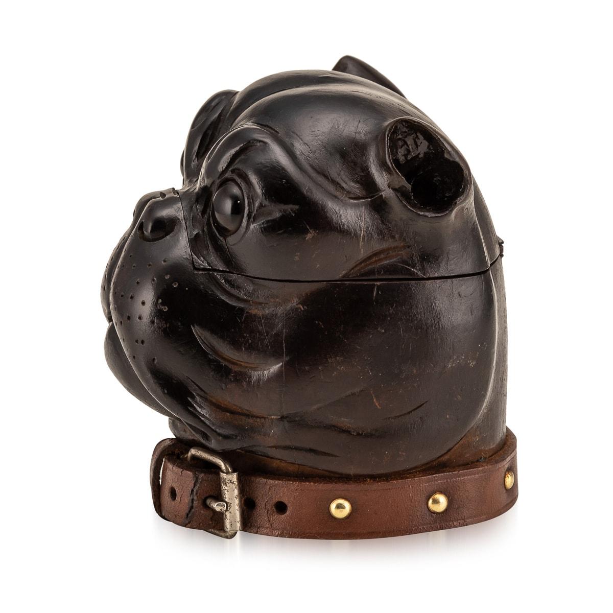 Antique 19th century Victorian lignum vitae inkwell modelled as the head of a bulldog with realistic red glass inset eyes, original leather collar with a copper buckle. The head is hinged and opens to reveal an empty ink pot insert compartment with