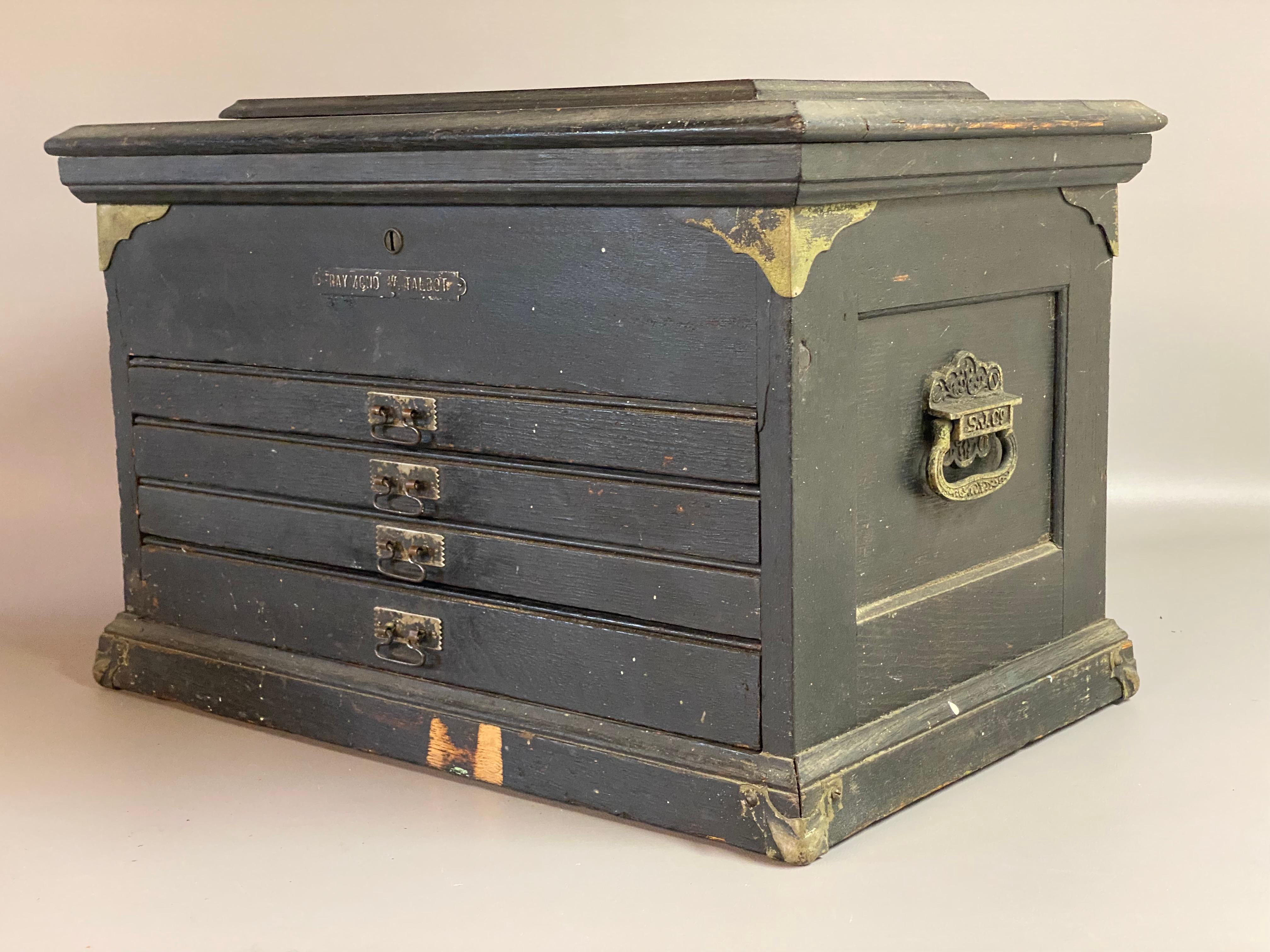 Old painted and distressed oak Late Victorian American machinist's tool box. Solid oak underneath the painted surface. The box is comprised of four drawers and a flip top cavity with brass hardware and corner mounts. The typical machinist's tool box