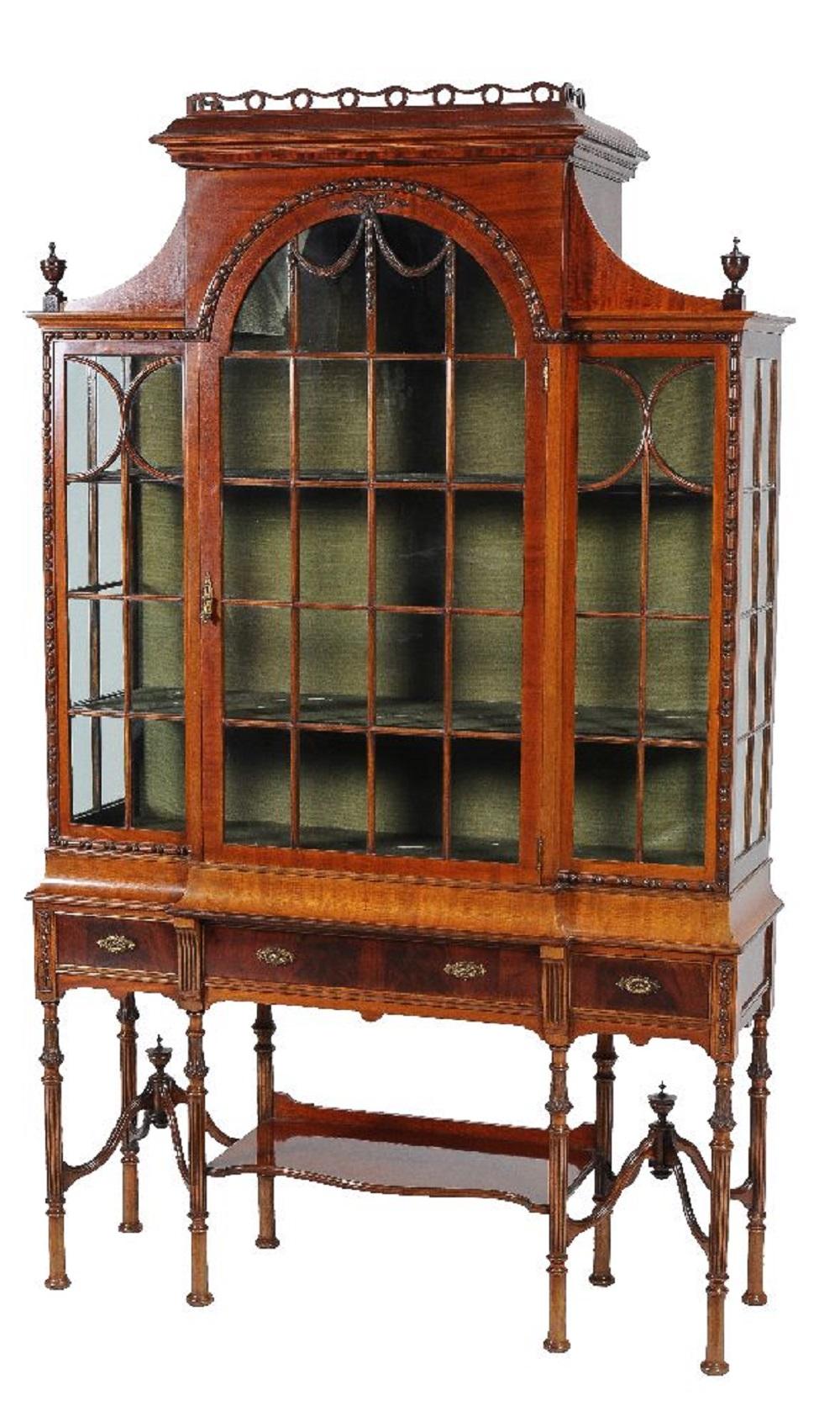 For sale is a good quality 19th century Victorian mahogany display cabinet on Stand. The cabinet has a large central arched door, above the stand. The stand has three drawers, each with brass handles. The cabinet stands on elegant legs, united by a