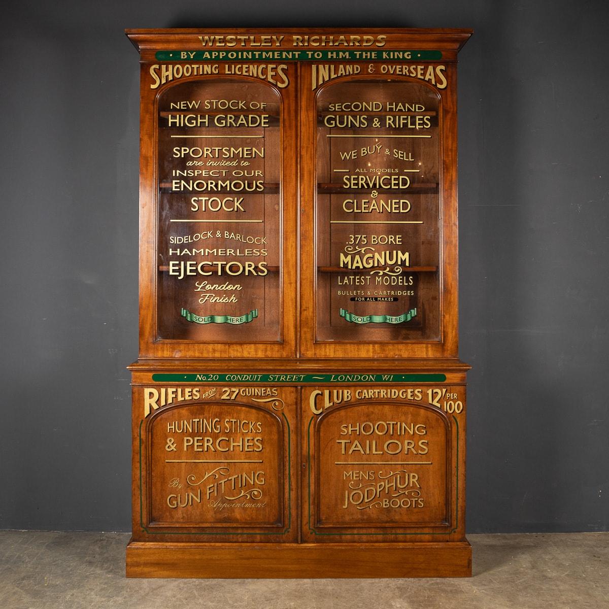 Antique late 19th Century Victorian mahogany glass fronted display cabinet, later painted for use in a gentleman's gun shop based in London. This stunning piece of British craftesmanship has been beautifully later painted with gold lettering on