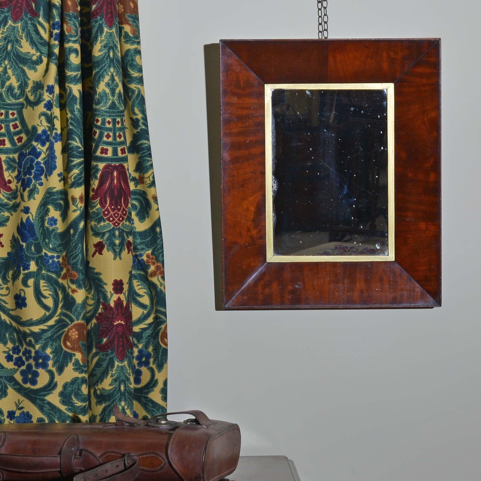 19th century mahogany hanging mirror
The frame with an inverted bevelled edge, veneered in well figured mahogany, gold slip and period mirror plate, which has a few marks to it.
British, circa 1850

54cm H, 44cm W, 5cm D.