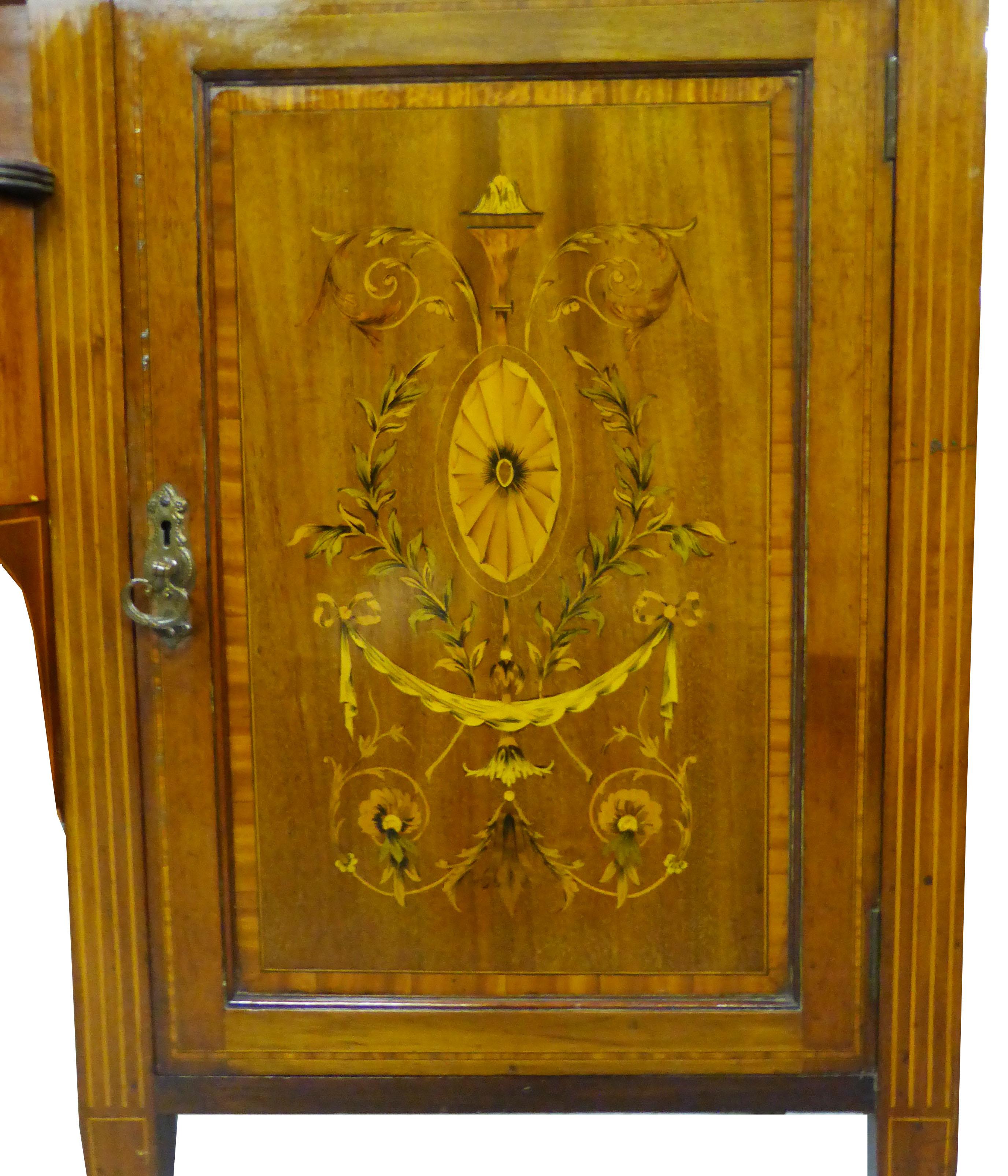 For sale is a fine quality early Victorian mahogany and marquetry inlaid sideboard of large proportions. The sideboard has two profusely inlaid doors, with a single drawer in between, also inlaid. The piece stands on tapering legs terminating on