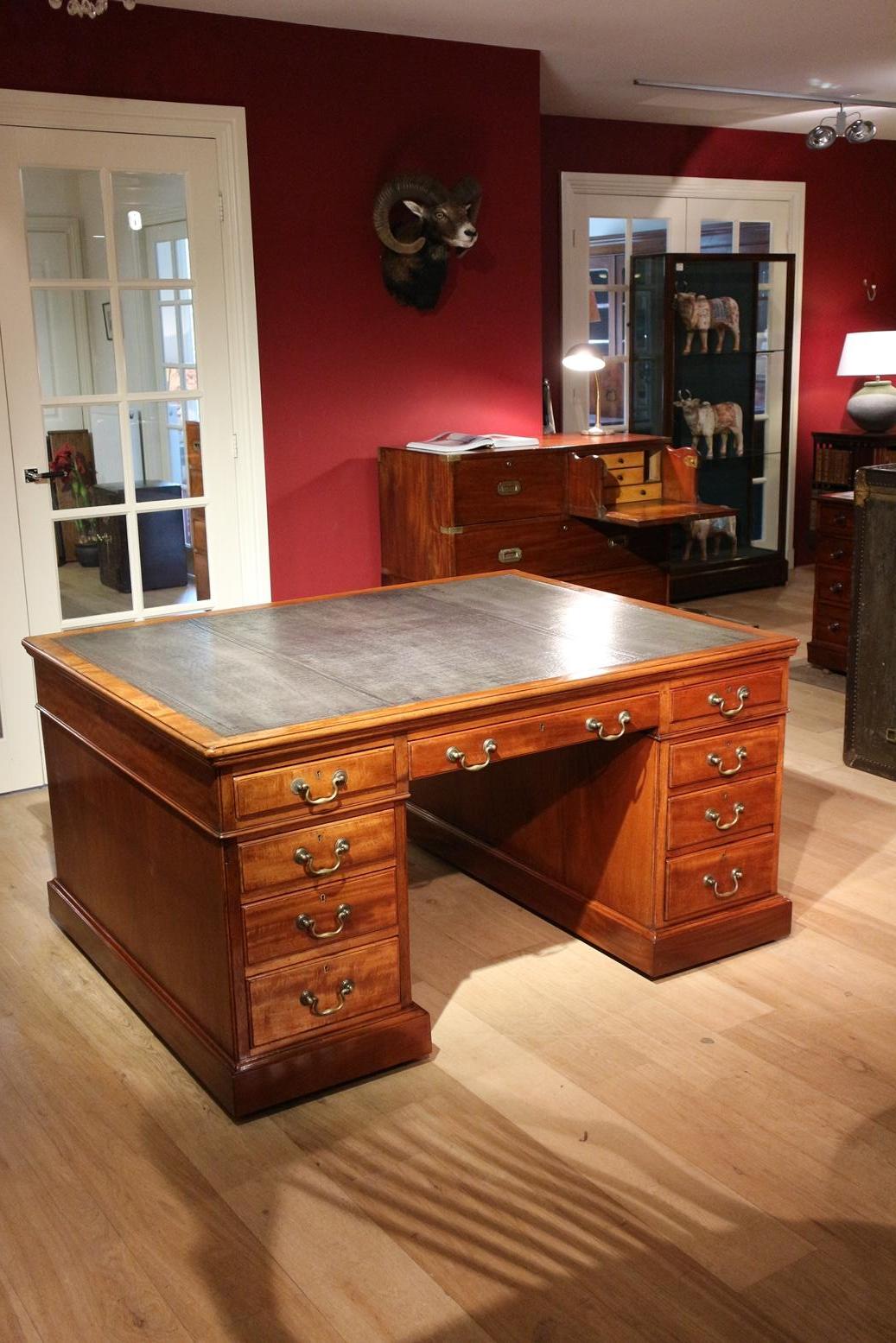 Impressive mahogany partner desk. 18 drawers. Due to the depth of 122cm it is very convenient to work with two persons. The fact that the desk has drawers on both sides is not only beautiful to see but also practical. Desk is in perfect condition.