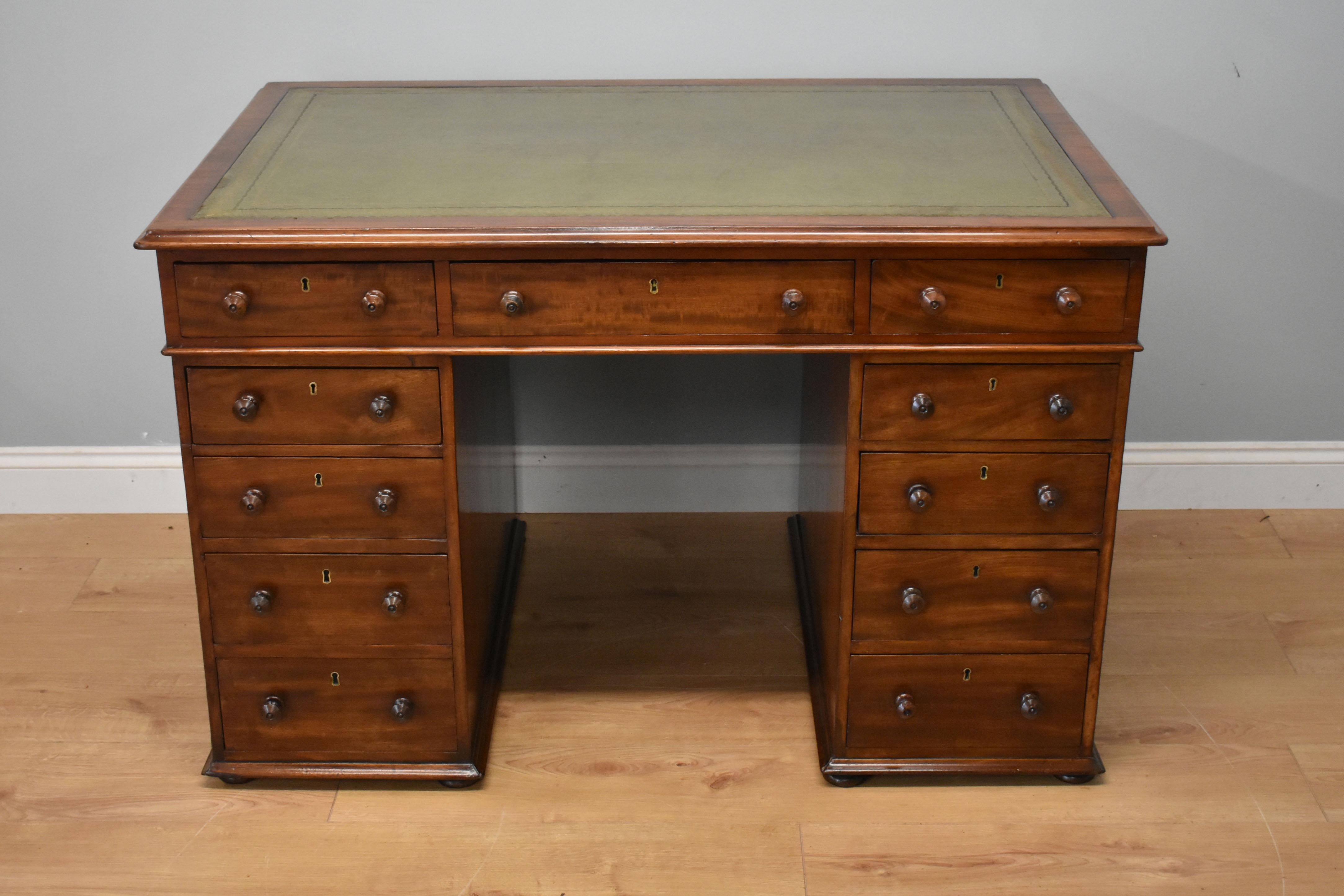 For sale is a good quality 19th century Victorian mahogany partners desk of small proportions. The top of the desk is inset with an antique green leather, with decorative gold and blind tooling. The top has three drawers on the front side, and three