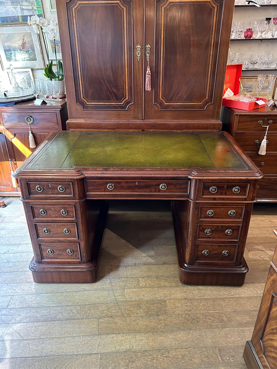 A high quality 19th Century Victorian Mahogany Pedestal Desk with tooled leathered writing surface, 9 solid mahogany lined drawers and original brass ring handles on a plinth base with working keys. Comes apart in three separate sections.

Circa: