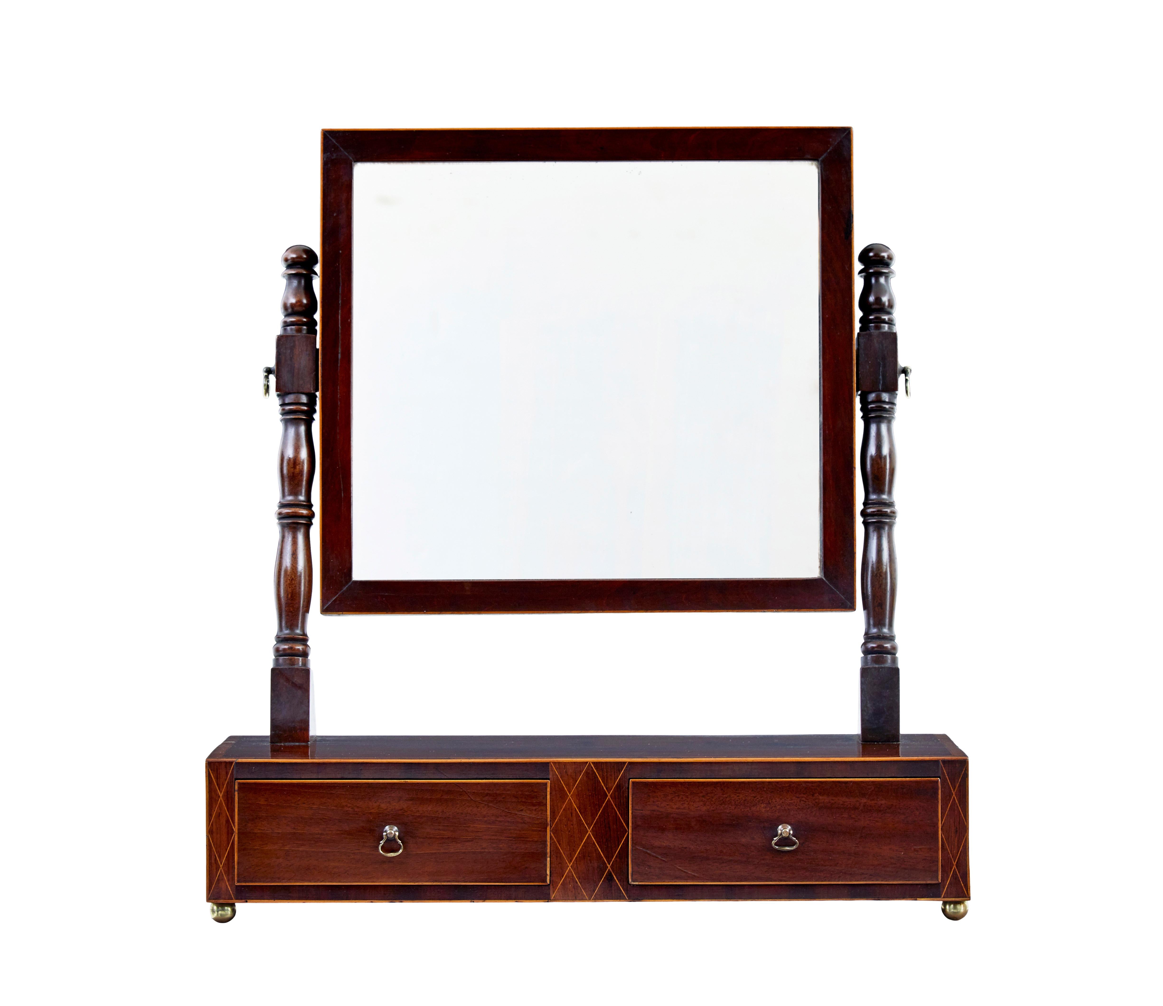 19th century Victorian mahogany toilet mirror circa 1860.

Good quality high Victorian toilet mirror, ideal for use today on a dressing table.

Mirror mounted in a bevelled frame with stringing detail, held in place by turned supports.  Rectangular