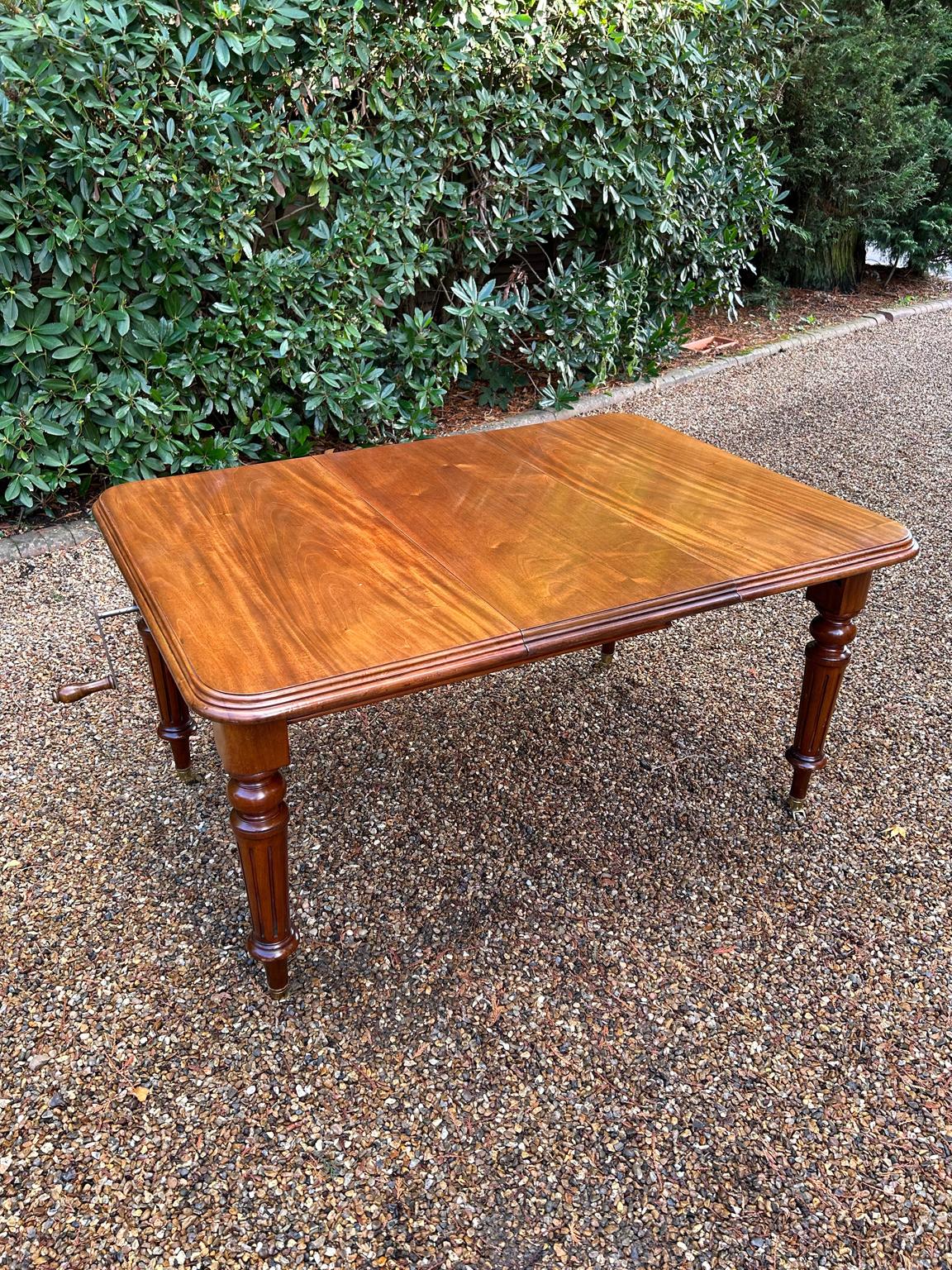 A very high quality 19th Century Victorian Mahogany Windout Dining Table, with a rectangular top and one extra original solid mahogany leaf, raised on turned reeded legs, terminating in brass castors. Including Windout Handle.

Circa: