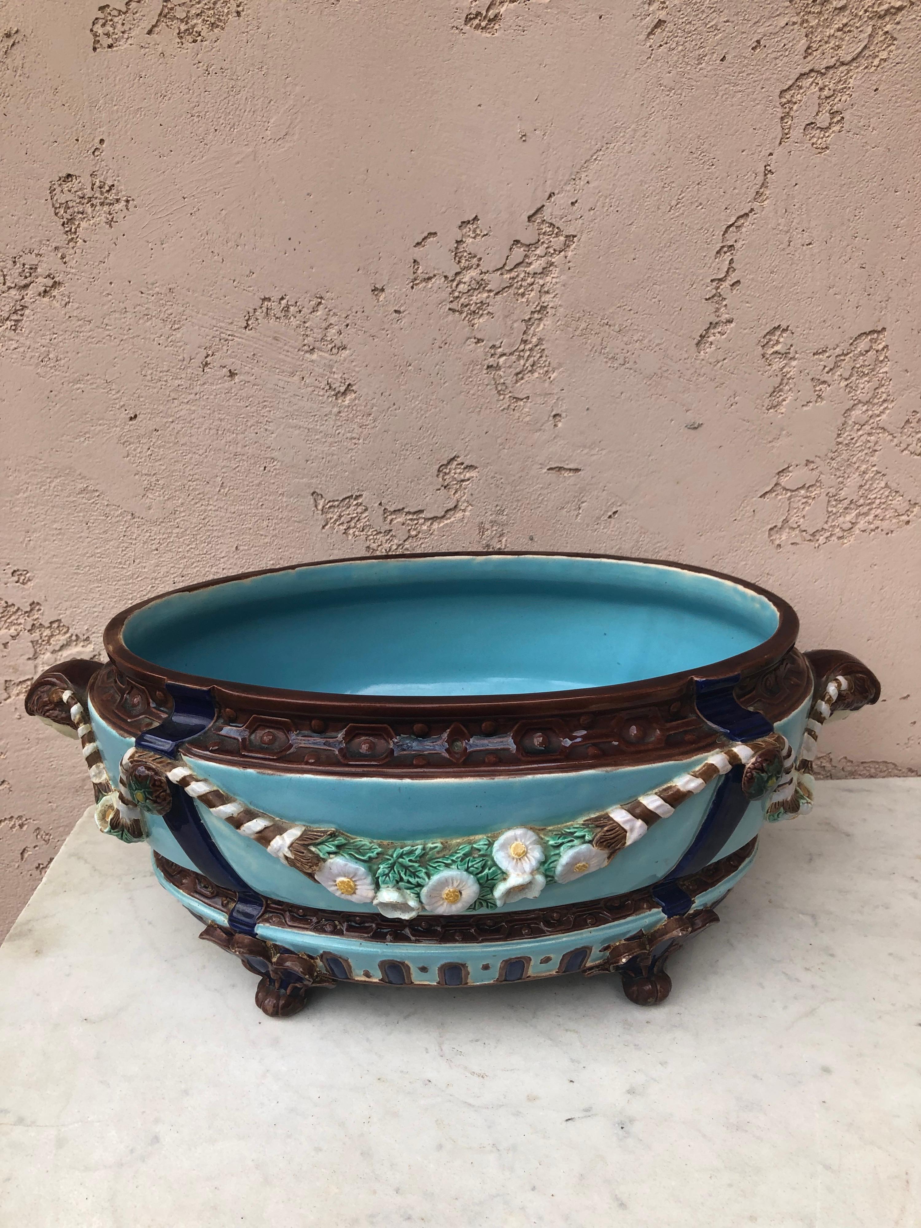 19th Century large Victorian Majolica jardiniere with garlands of flowers, the handles are women heads signed Joseph Holdcroft.