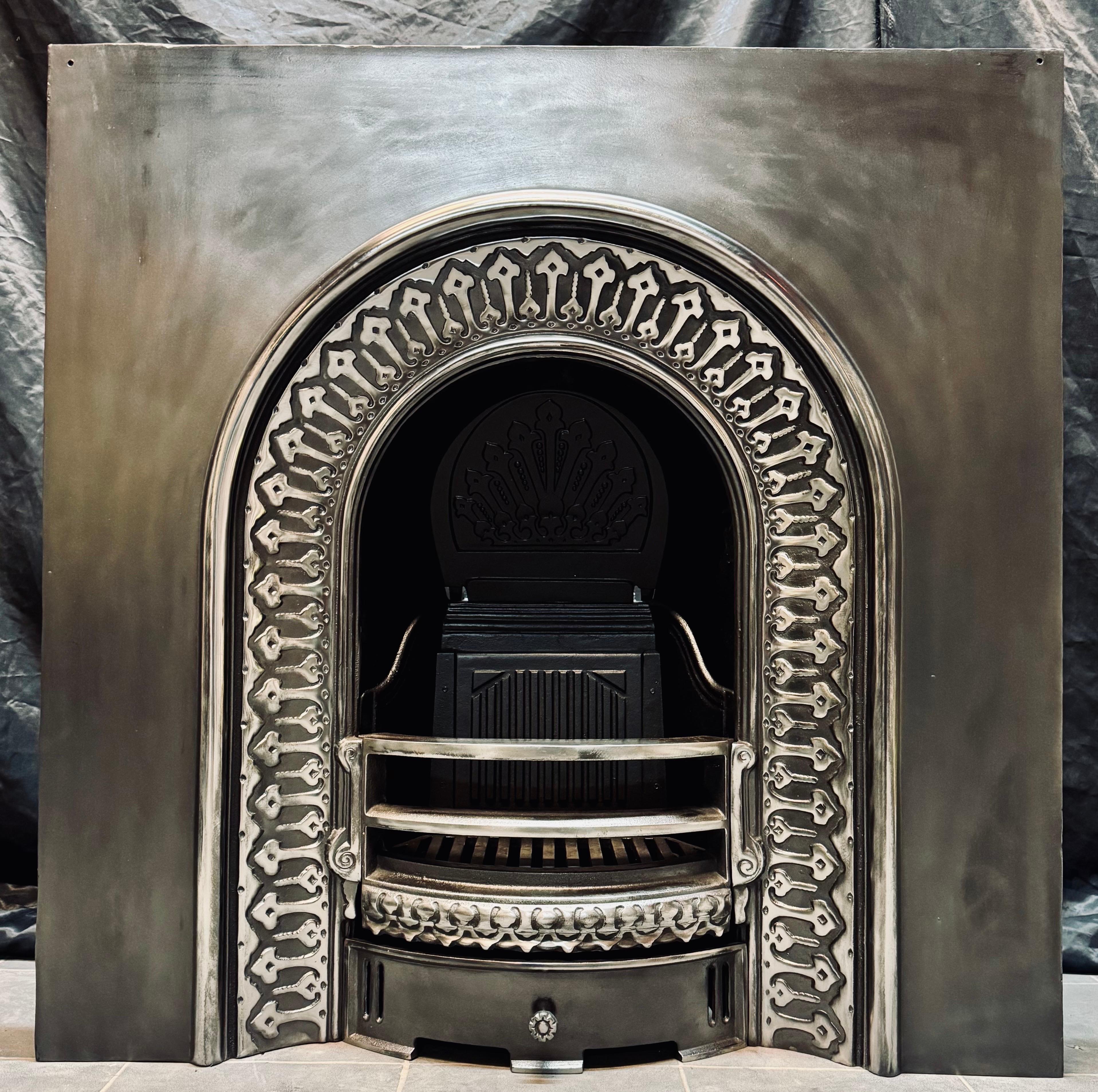 A matching pair of 19th Century Victorian manner cast iron fireplace inserts. A generous outer plate set with an arched high relief border, the three bared arched fire front with ash pan door below, complete with their original damper ventilation