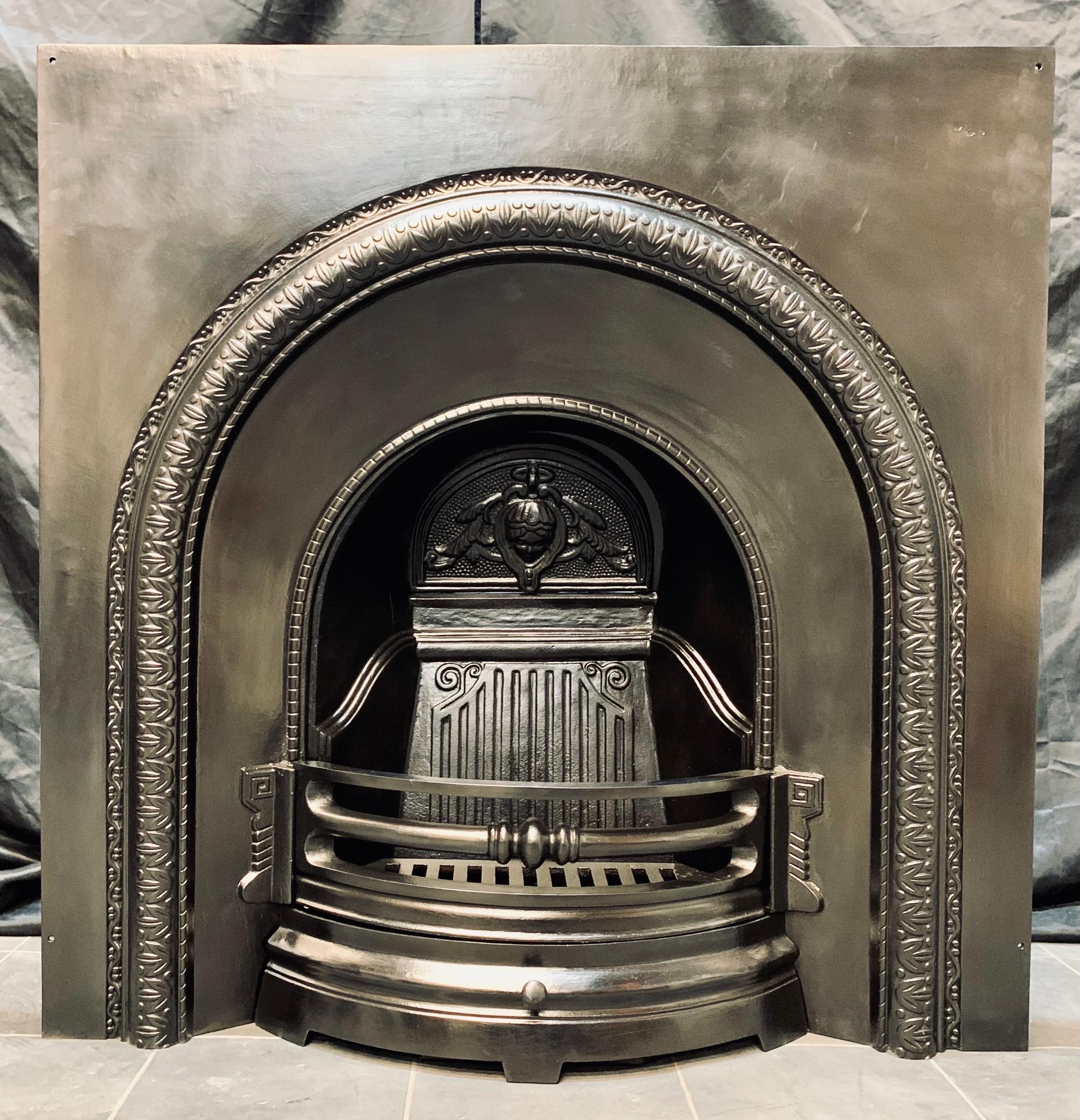 A pleasing 19th century Victorian manner cast iron fireplace insert. A generous outer plate with a raised border, the three barred curved fire front with ash pan door below. Movable damper to the inside, comes with a shaped ash pan.