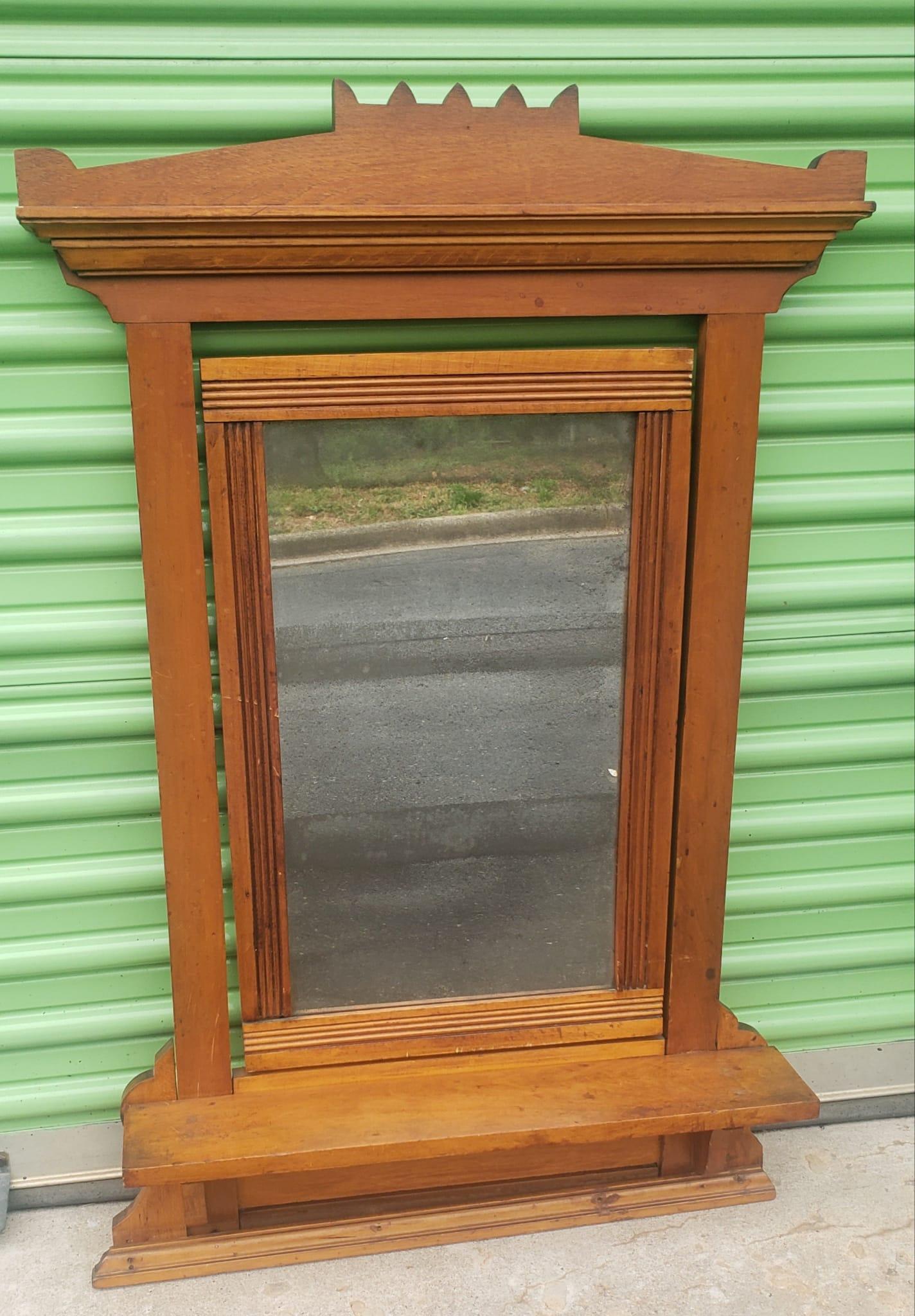 A 19th century maple framed shaving mirror measuring 26.5