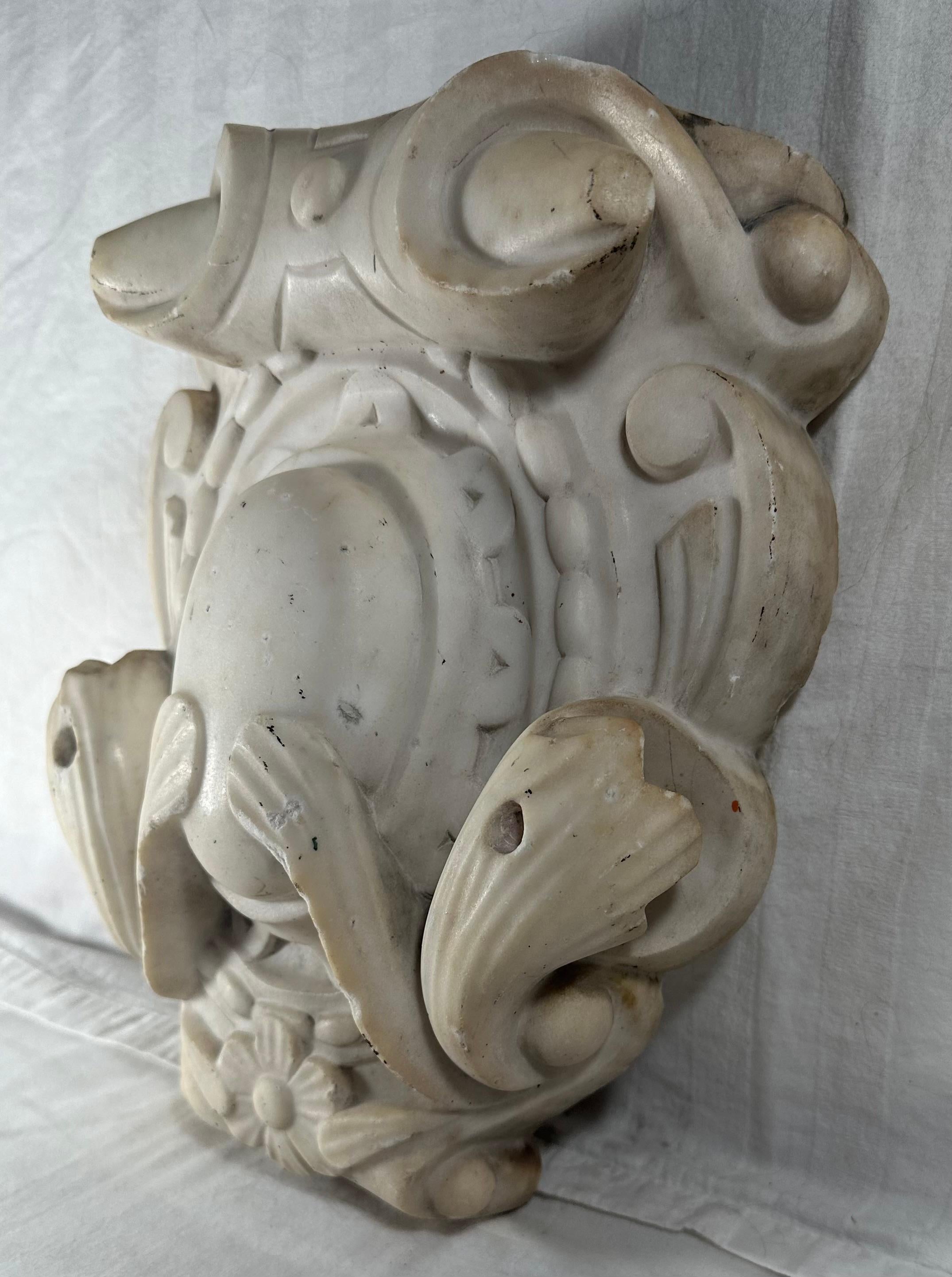 19th Century Victorian Marble Fireplace Mantle Keystone

Delicately carved architectural cartouche made from white Carrara Marble. This antique keystone is the centerpiece of a Victorian marble fireplace mantle. It is original and remarkably intact.