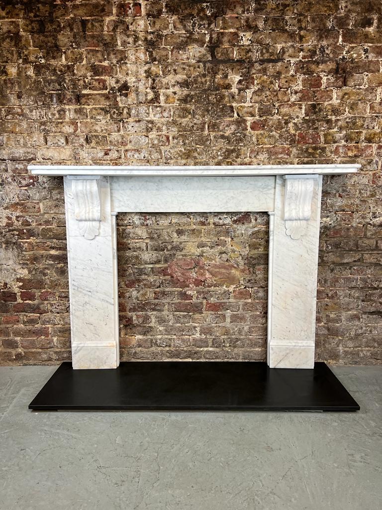 19th Century Victorian marble fireplace mantlepiece.
Antique original fireplace hand victorian carved corbels & shells in Italian carrara marble.
recently salvaged and restored from a london town house.

Dimensions: 
Shelf width 68.5