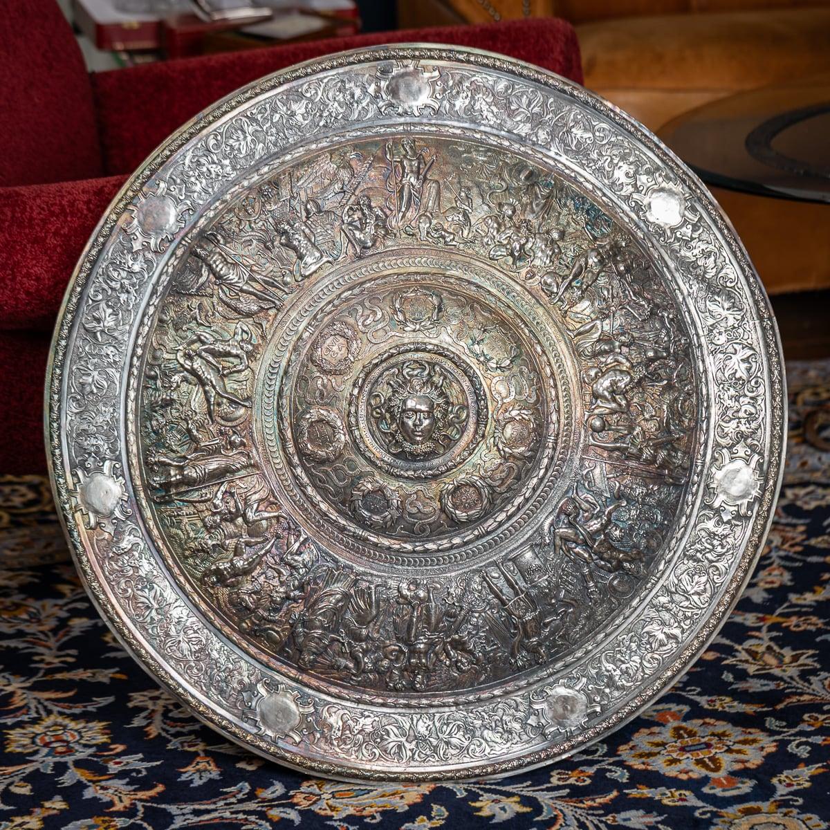 Antique 19th Century Victorian silver plated Elkington made parade shield, made after the 1552 original by Jorg Sigman. This shield is a work of art, made for display rather than battle. In the 16th century, armor served more than just a protective