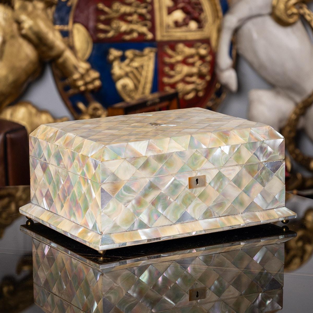 A stunning late 19th Century Victorian mother of pearl applied jewellery box. Dating back to 1880, this box has a fully covered outer body including the escutcheon. The hinged lid features a blank crest in solid silver. The inside of the jewellery