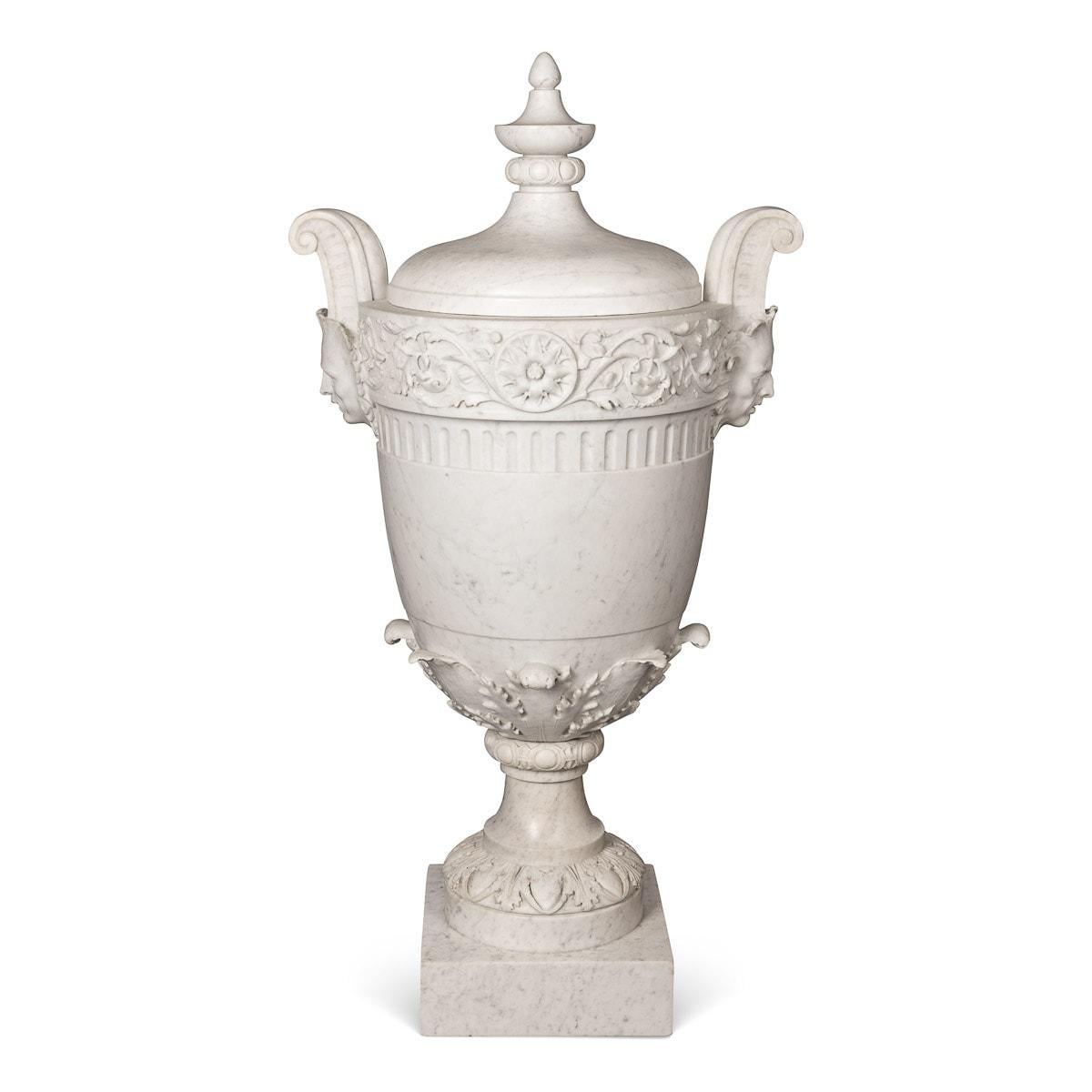 Antique mid-19th century Victorian Neo-Classical large and impressive marble urn with cover. The body decorated in high relief with large floral motif band, centred with a floral roset, the sides with carved faces with pertruding scroll handles,