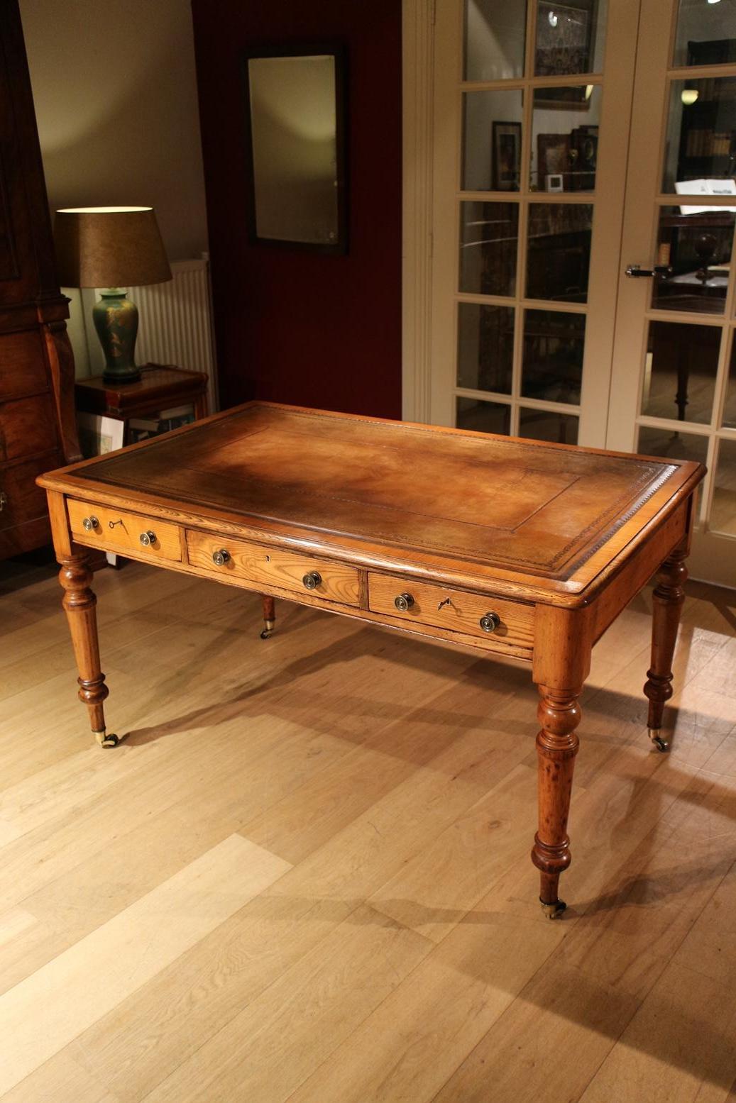 Beautiful light oak antique Victorian writing table with 3 drawers in good condition. Top has beautiful brown aged leather. Table is on brass wheels.

Origin: England

Period: circa1840-1850

Size: 136cm x 85cm x H. 75cm (legroom 60.5cm).