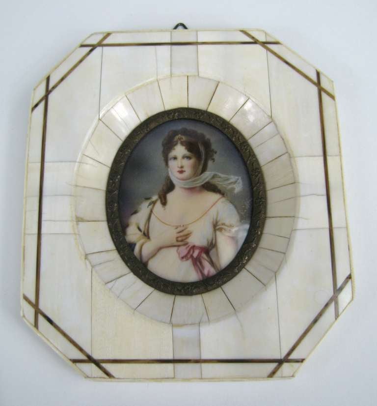 Miniature Victorian portrait painted on porcelain with a bone set in a wonderful inlaid bone frame. Would be a wonderful addition to your decor. Measures: 5 in x 4.25 in.