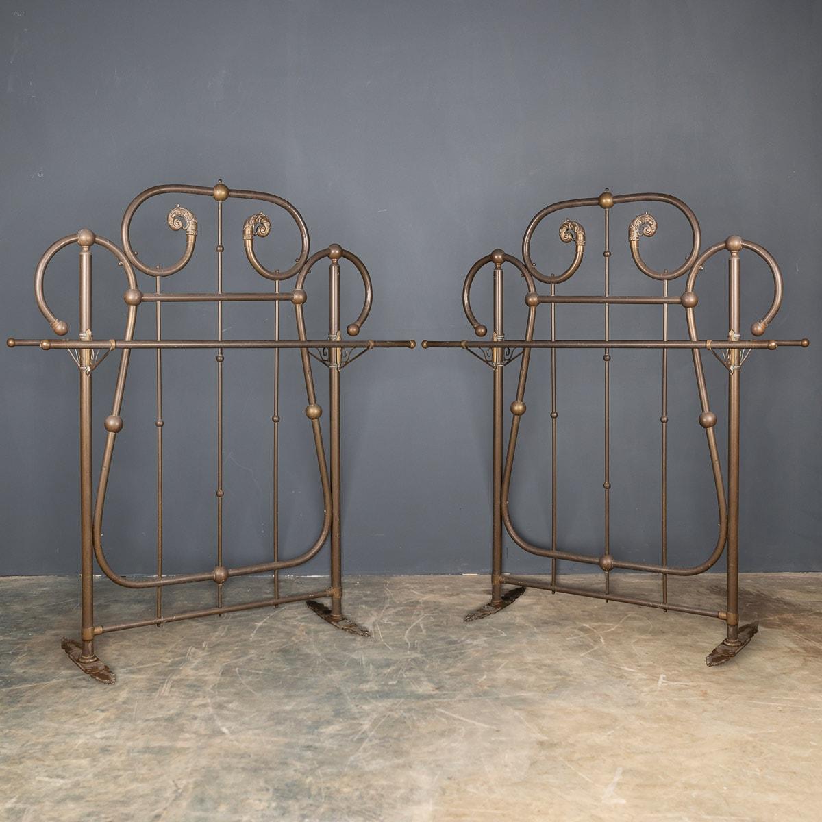 Antique 19th Century pair of huge coat stands from a Victorian hotel. These large brass pieces have rails on both sides and feet that secure to the floor. A fabulous statement piece for a restaurant, club or a large dressing room.

CONDITION
In