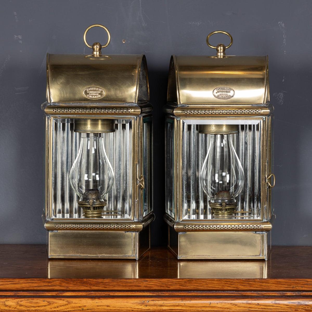 Antique 19th Century Victorian pair of oil lamps by Davey & Co London Ltd. Made from brass and bevelled glass, with a faceted panel in the back to reflect the light, these lamps were used to light the insides of yacht cabins but could be carried by