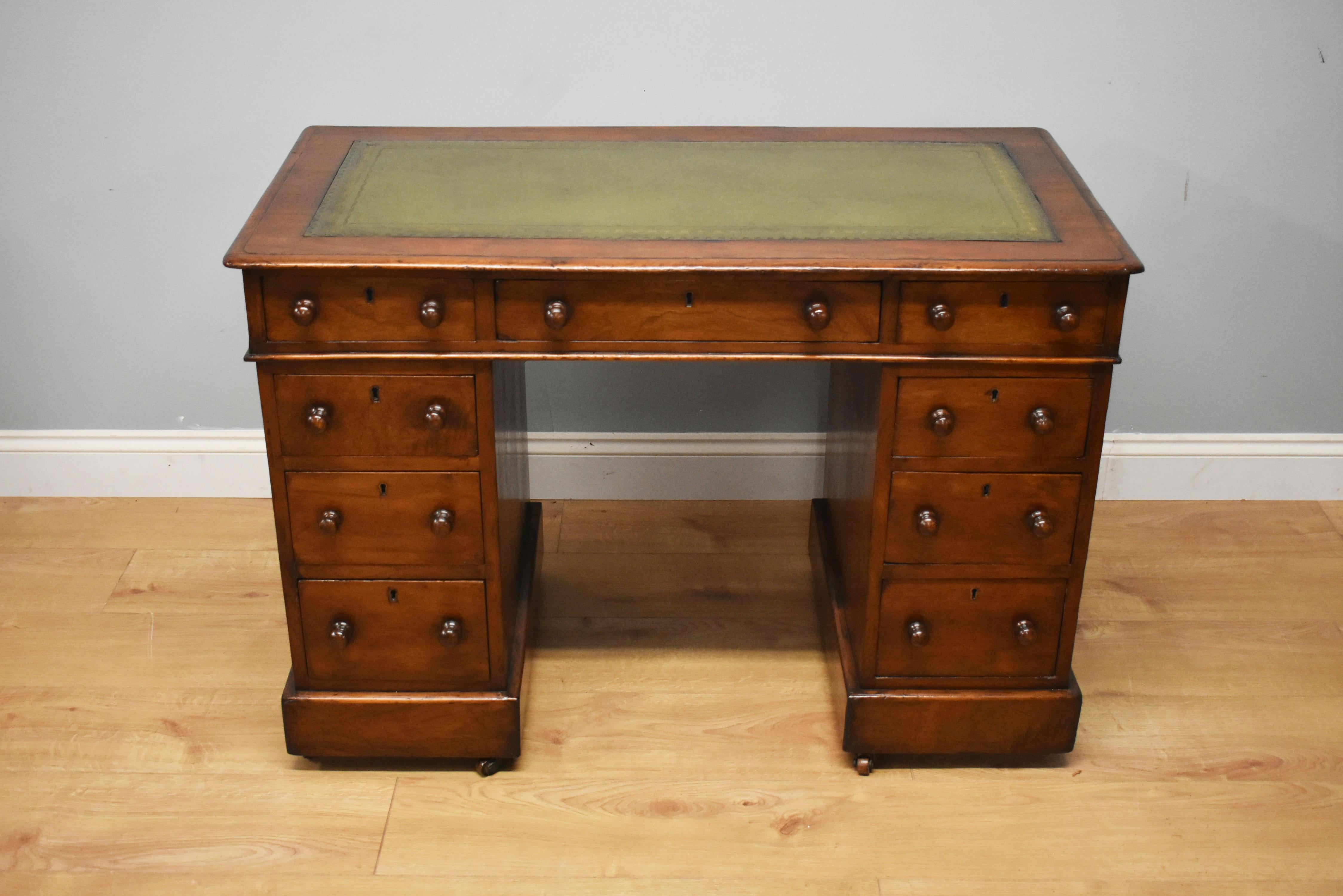 For sale is a 19th century Victorian pedestal desk. The top of the desk having a green leather insert with decorative gold tooling, above three drawers, each with turned handles. The top fits onto two pedestals, each having a further three drawers