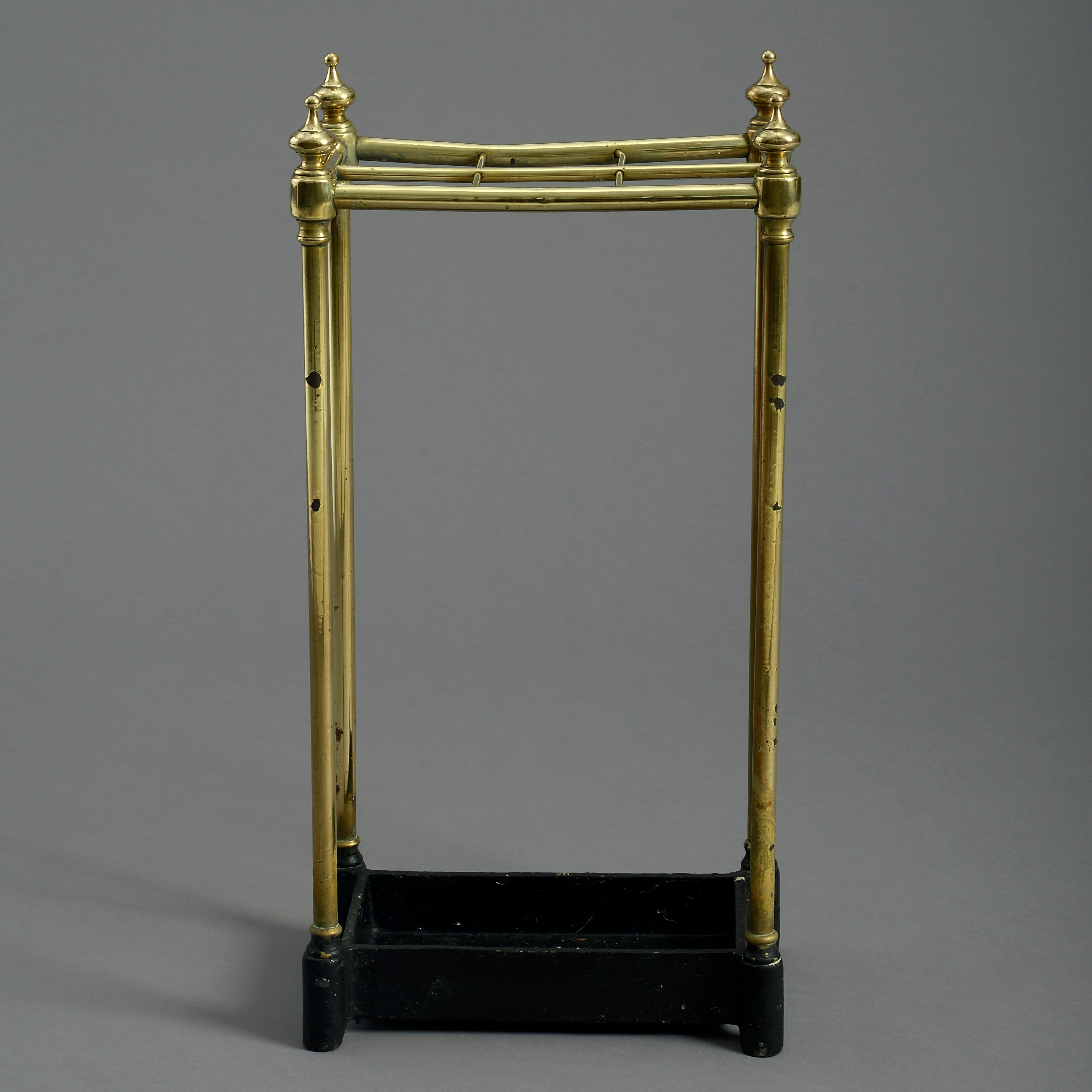 A mid-nineteenth century Victorian Period rectangular brass stick or umbrella stand, the brass finials above six square dividers, raised on tubular supports and terminating in a black painted cast iron drip pan.