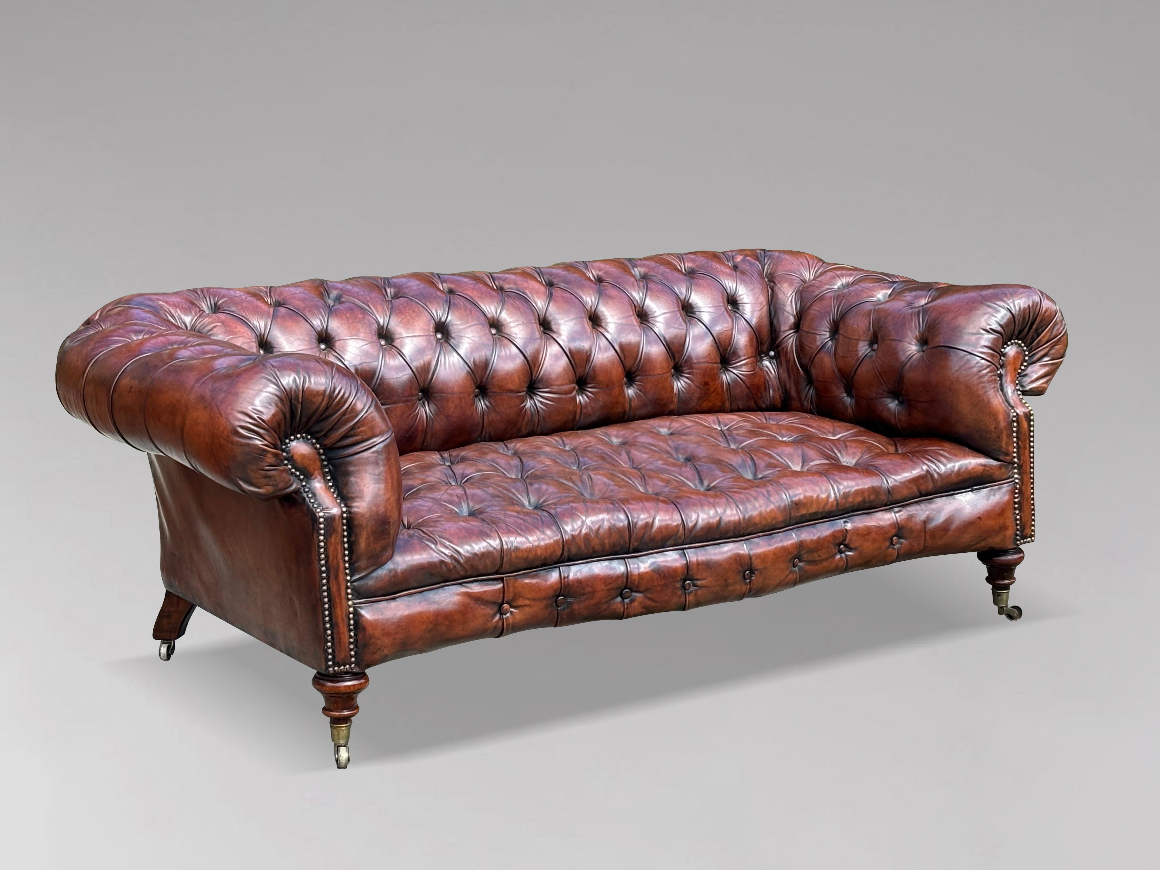 A stunning and rare 19th-century Victorian period large three-seater serpentine leather button-down brown Chesterfield sofa. It features the original brown leather hide that has been cleaned and polished, with horsehair padding, giving it a lovely