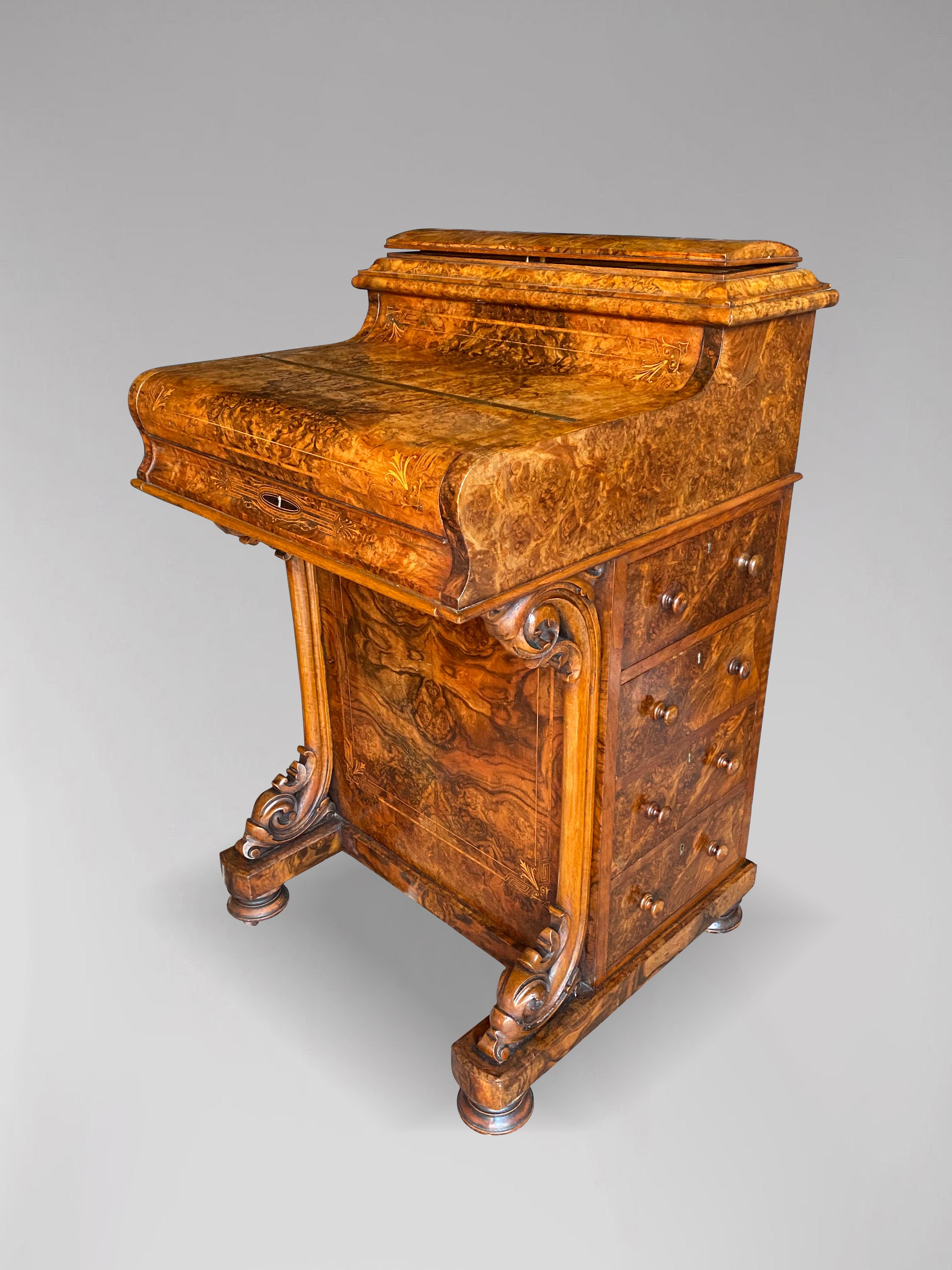 A stunning 19th century figured burr walnut Davenport desk. The piano top fall lifts to reveal 2 burr walnut veneered drawers and a pull out and adjustable writing slope which retains the original gold tooled red leather writing surface. This