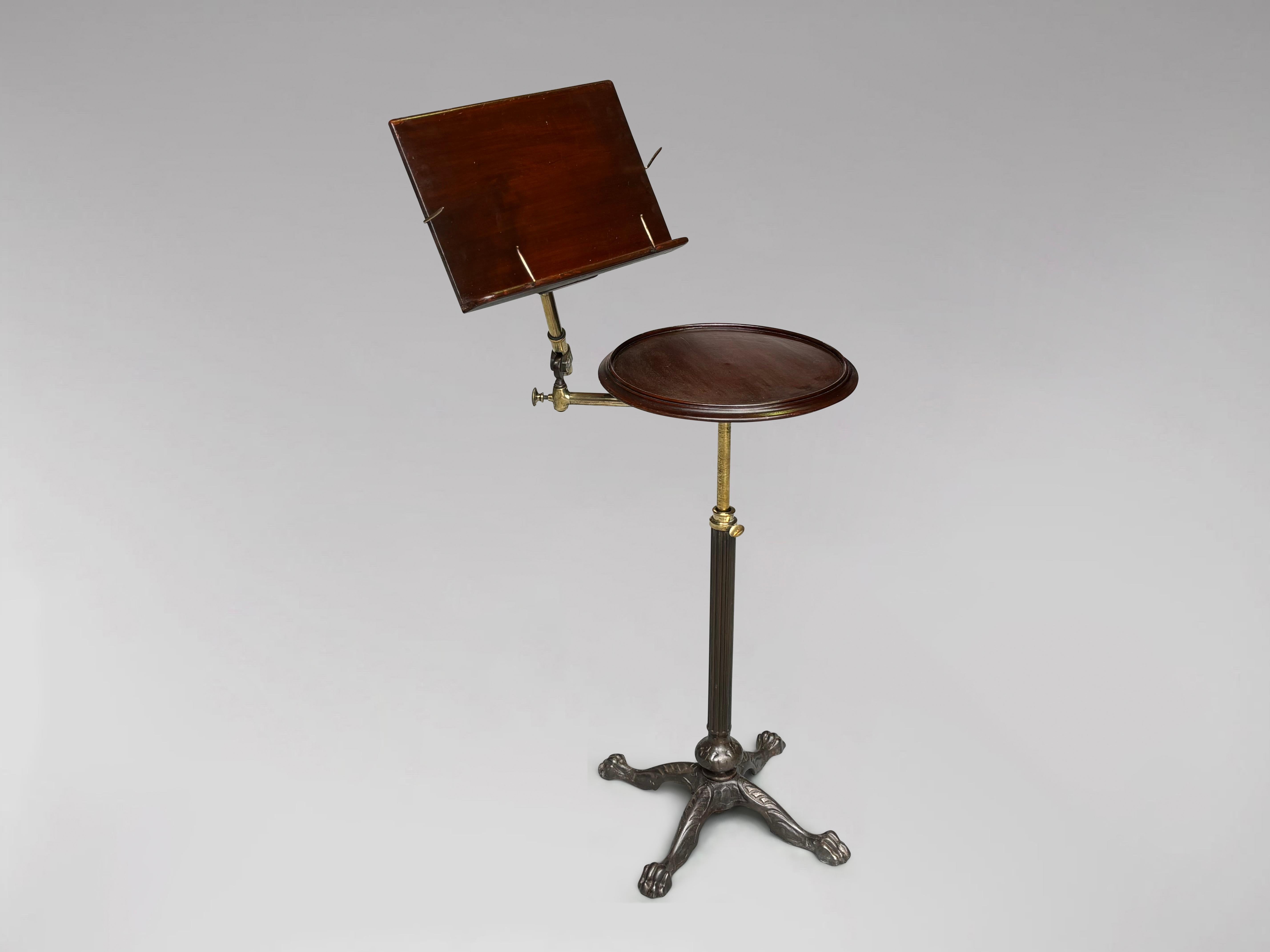 Superb quality late 19th century adjustable rectangular reading stand with circular table. Two solid mahogany tables which can be used flat or angled on a brass column with a brass adjustable mechanism above a heavy cast iron reeded column and