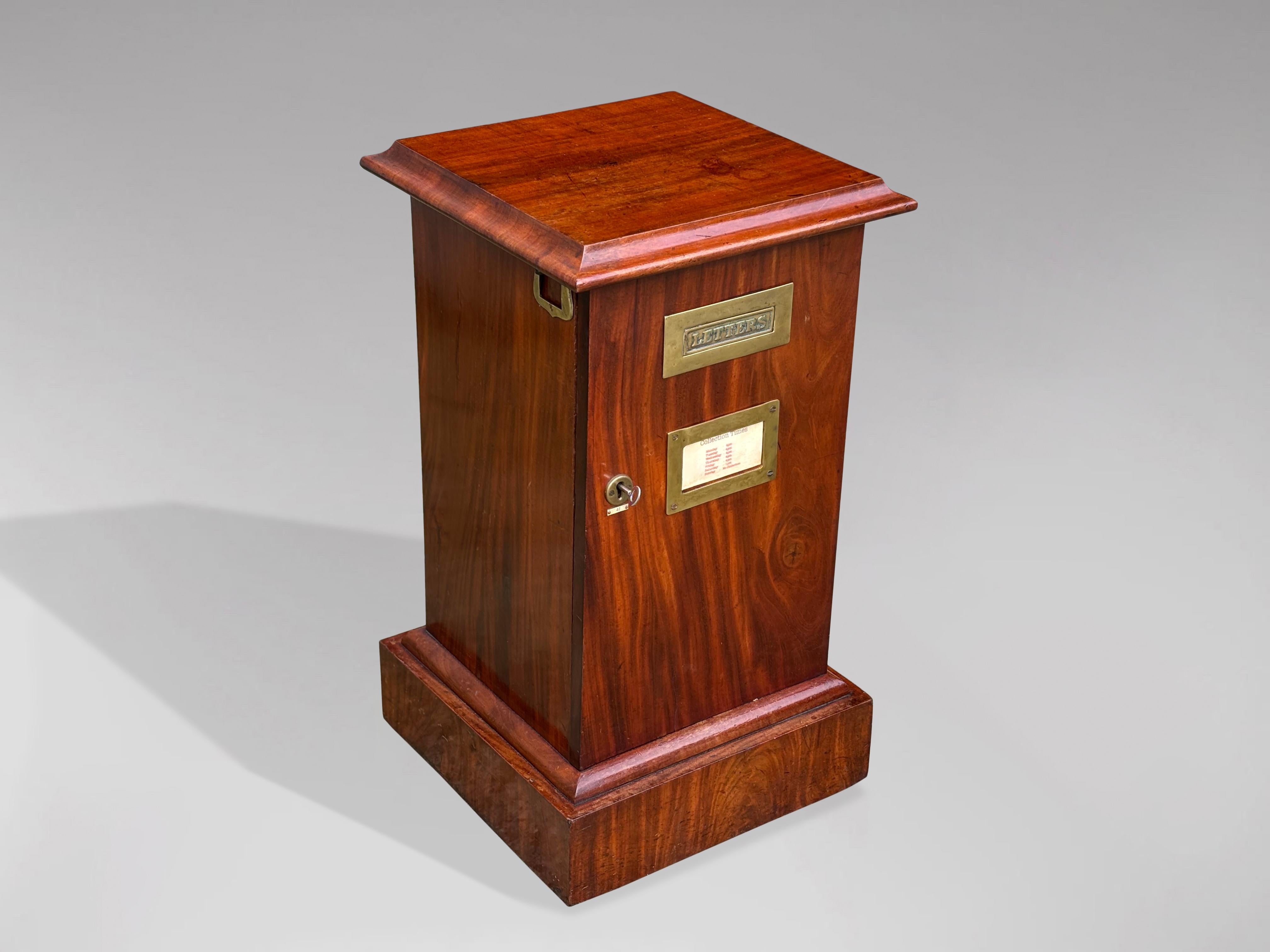 A tall attractive late 19th Century Victorian period figured mahogany country house post box or letter box. A moulded top above a hinged door with a brass plate engraved 'Letters' and a shuttered posting slot, the door with working lock and key,
