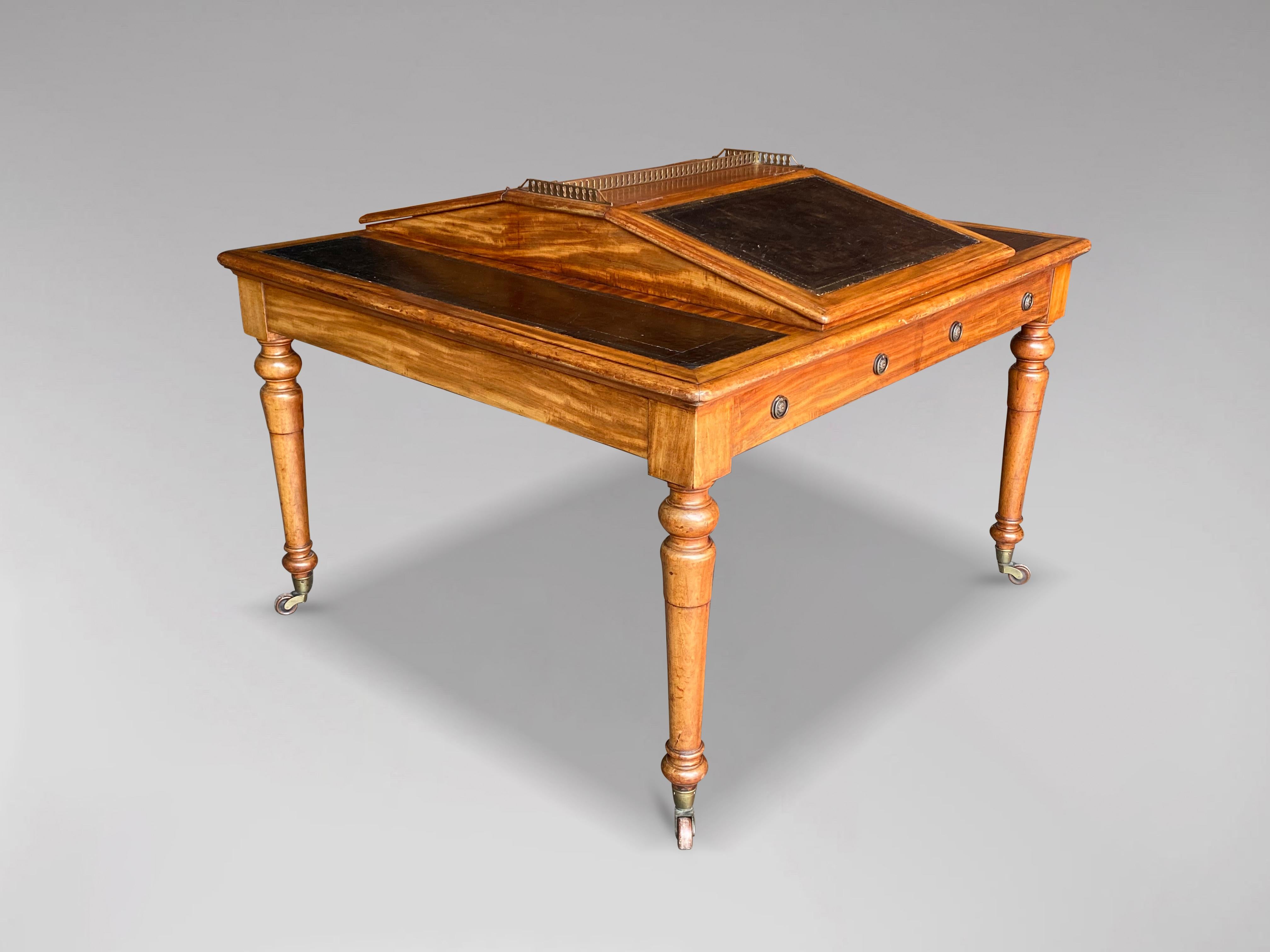 A fine late 19th century, Victorian period mahogany partners writing table with unusual features such as a moulded rectangular top with two rising fall writing slopes in the centre topped by a brass galleried top, above two faux drawers on either