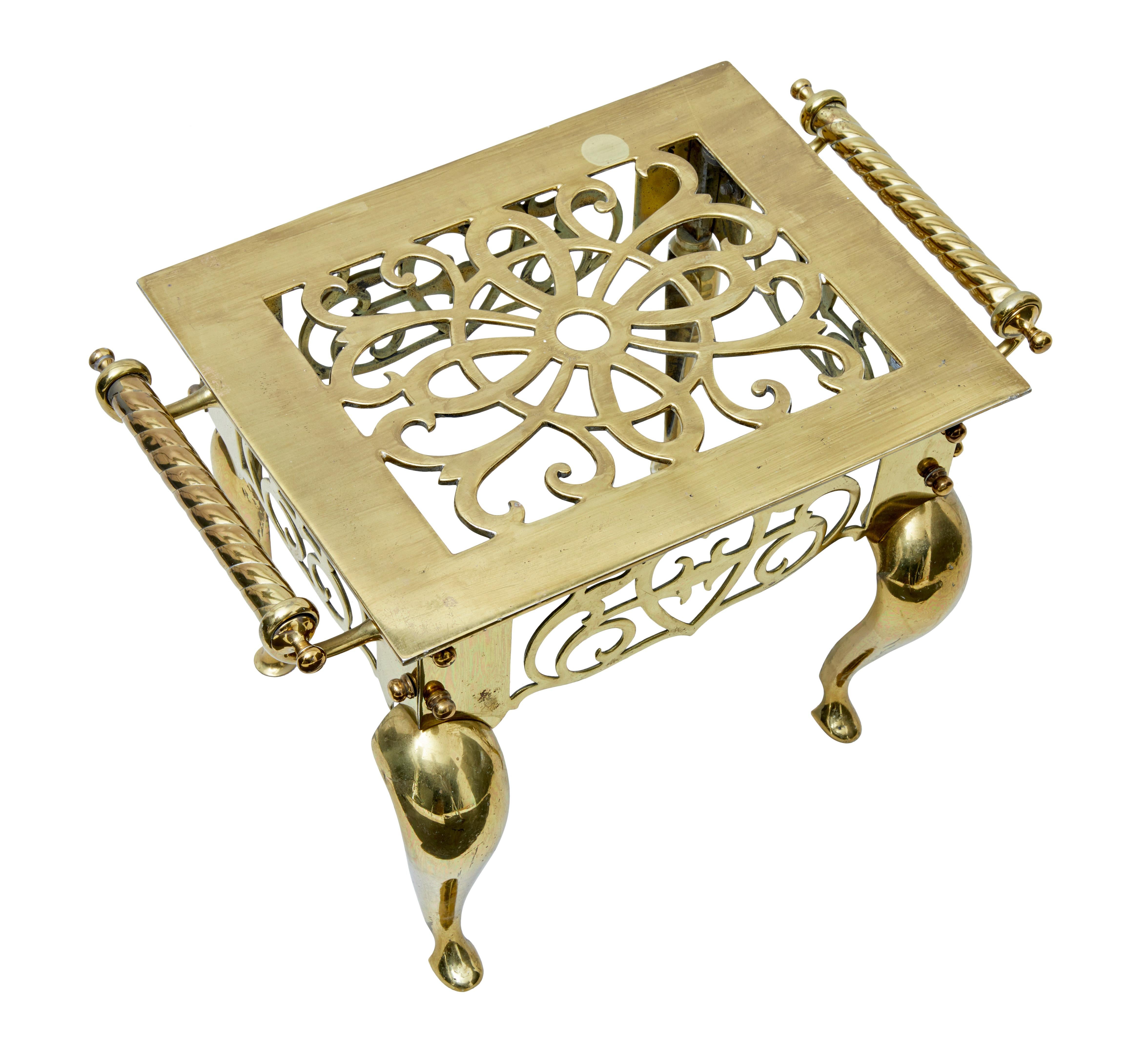 Good quality stamped Victorian brass trivet footman.

Pierced design to the top and sides, spun brass handles to the sides.

Stamped on the underside twice.