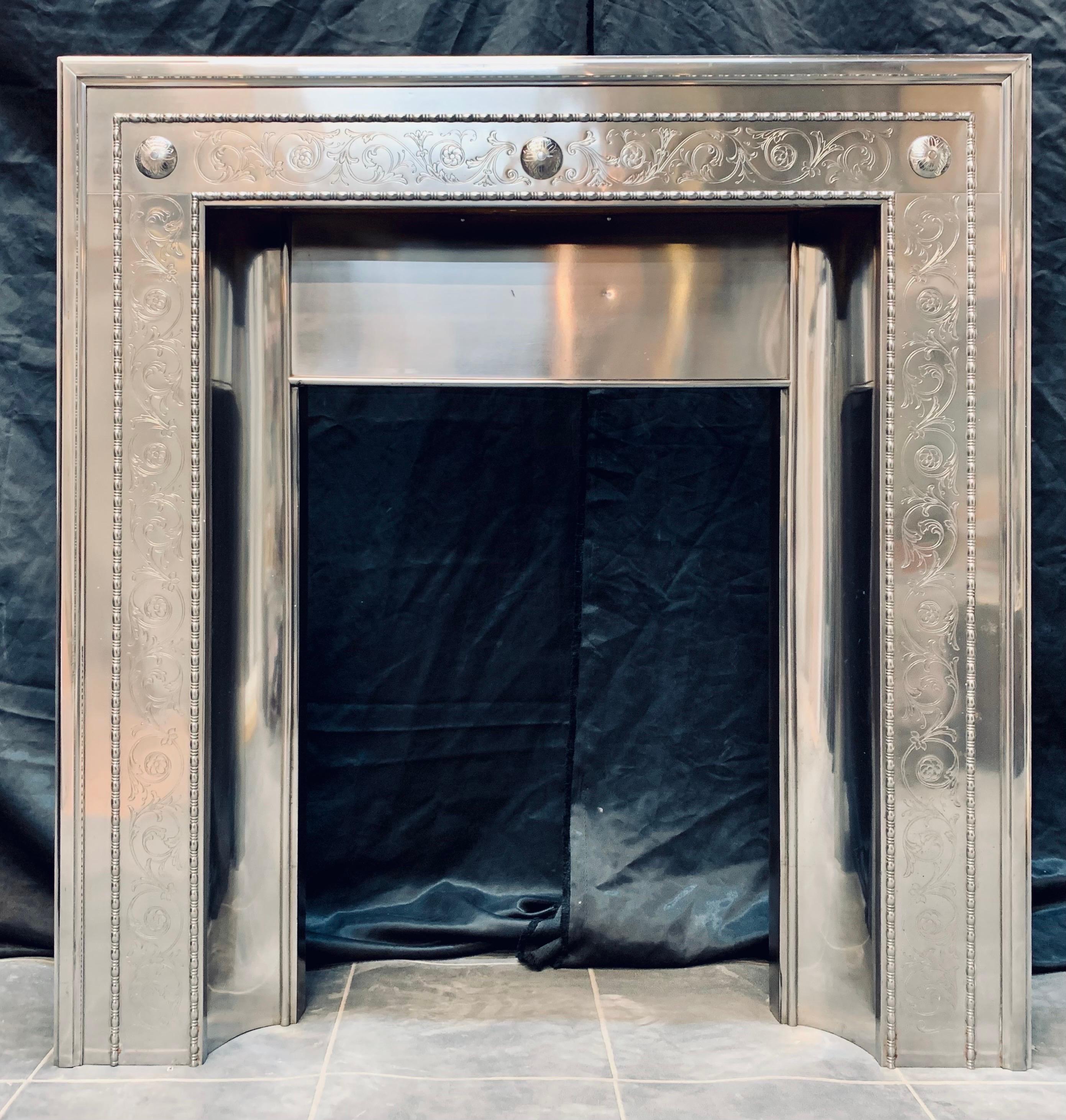 A wonderful example of a 19th Century late Victorian polished steel fireplace insert. A raised moulded border fixed to hand etched front panels, the cross lintel with further etched tendrils and raised and etched bullseyes. A central panel over the